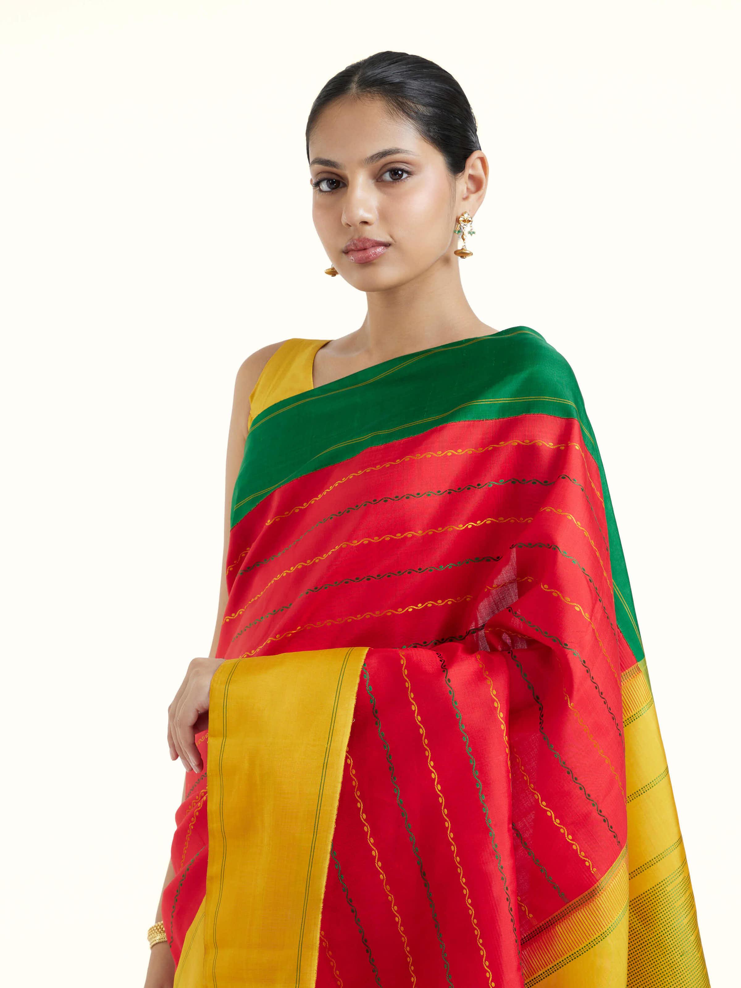 Angled view of red silk Kancheepuram saree highlighting rich silk weave