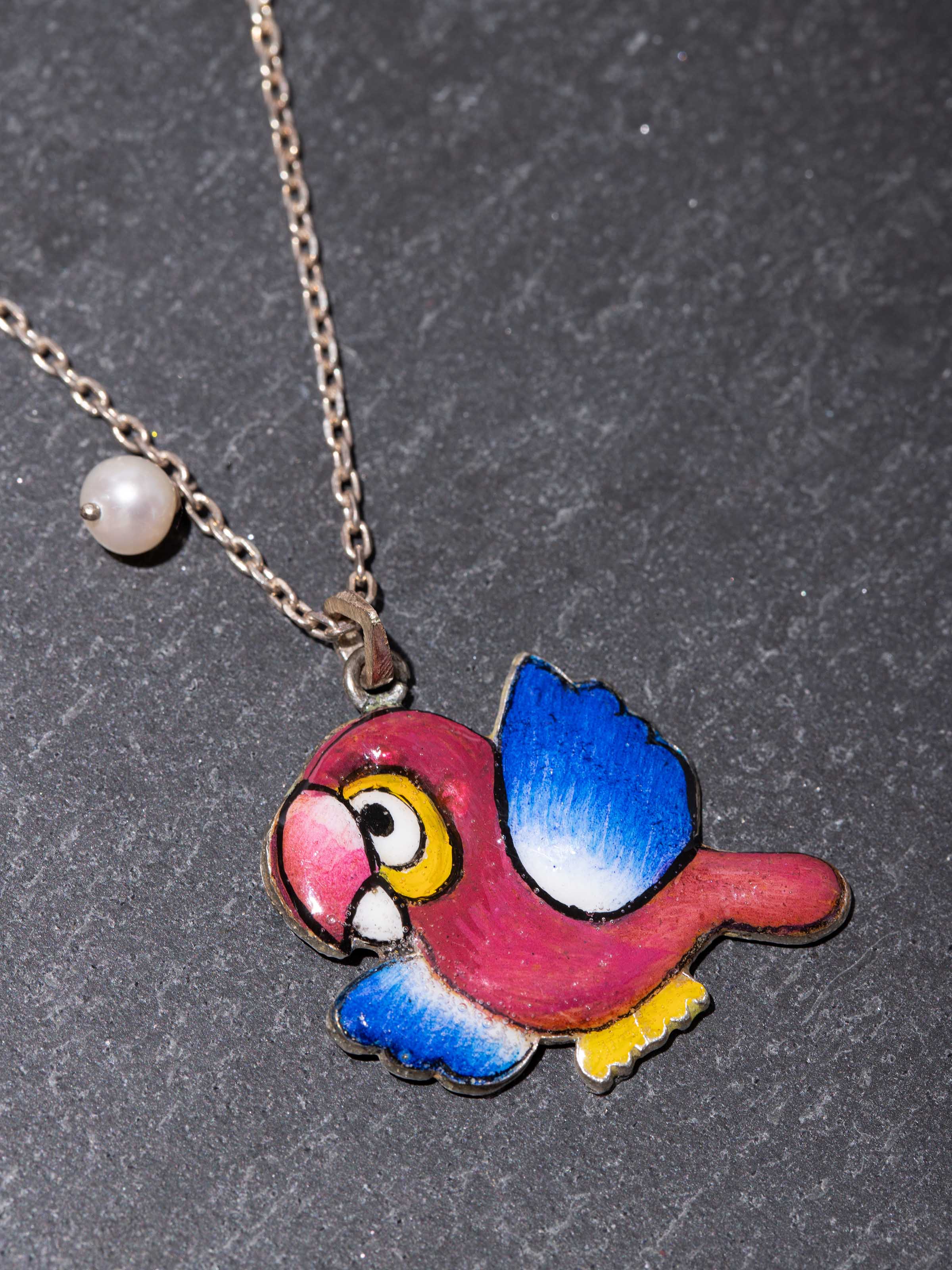 Detail shot of Gulabi Meenakari silver pendant capturing hand-painted enamel and delicate silverwork.