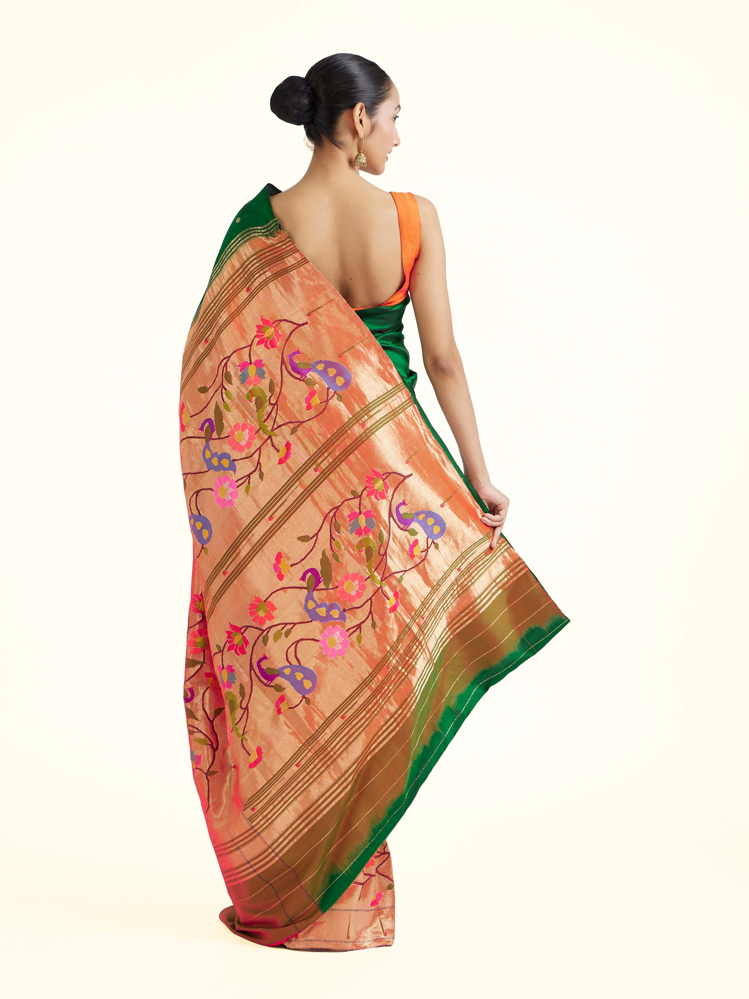 Back view of green silk Paithani saree displaying ornate pallu design