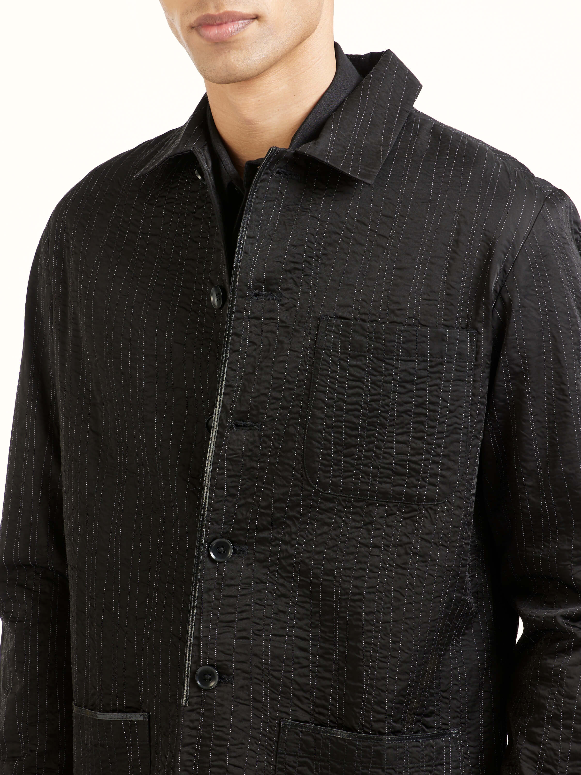 Detail view of black quilting ethnic jacket showing stitching craftsmanship