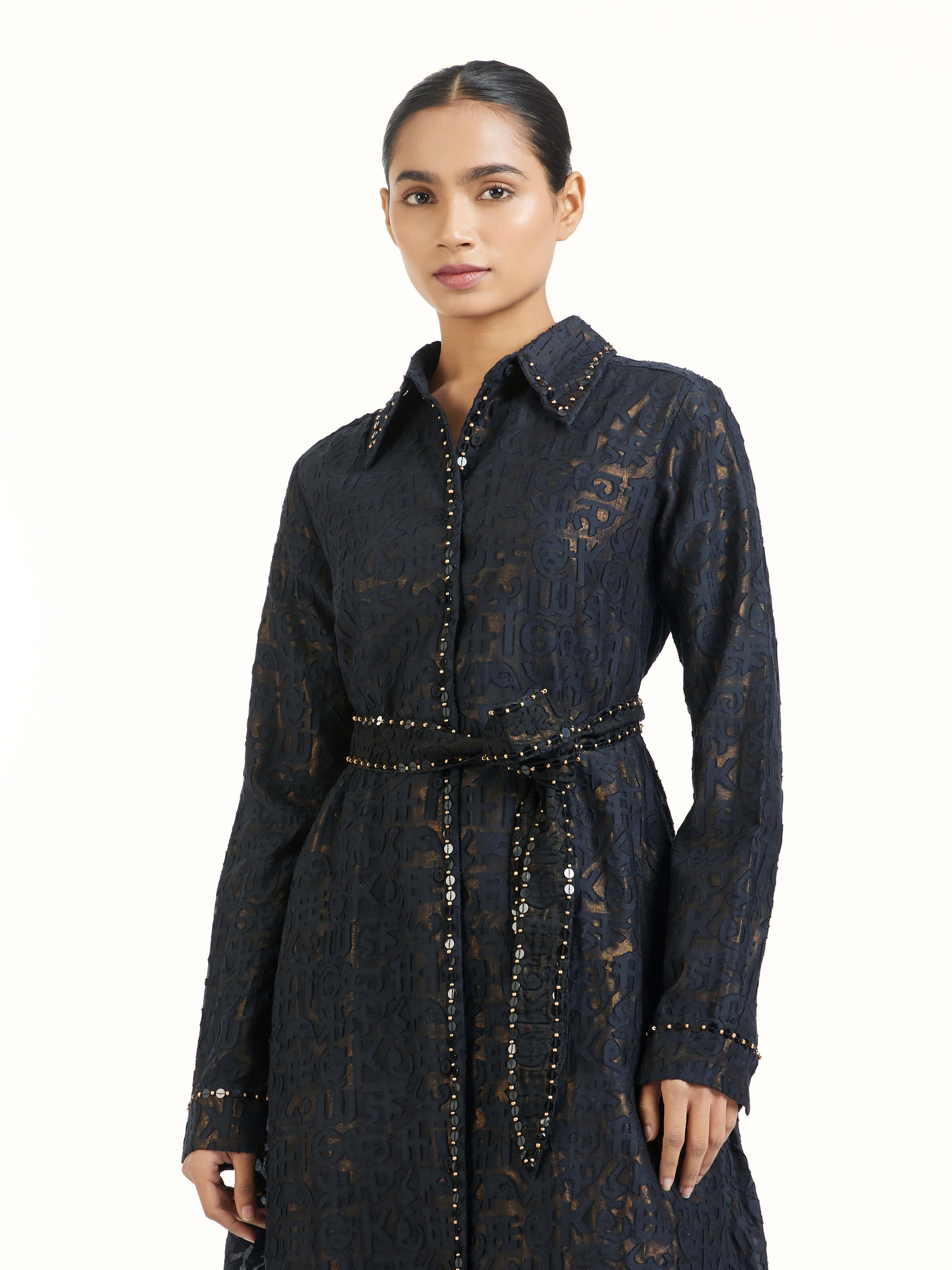 Angled view of black handloom cut work dress emphasizing handcrafted texture