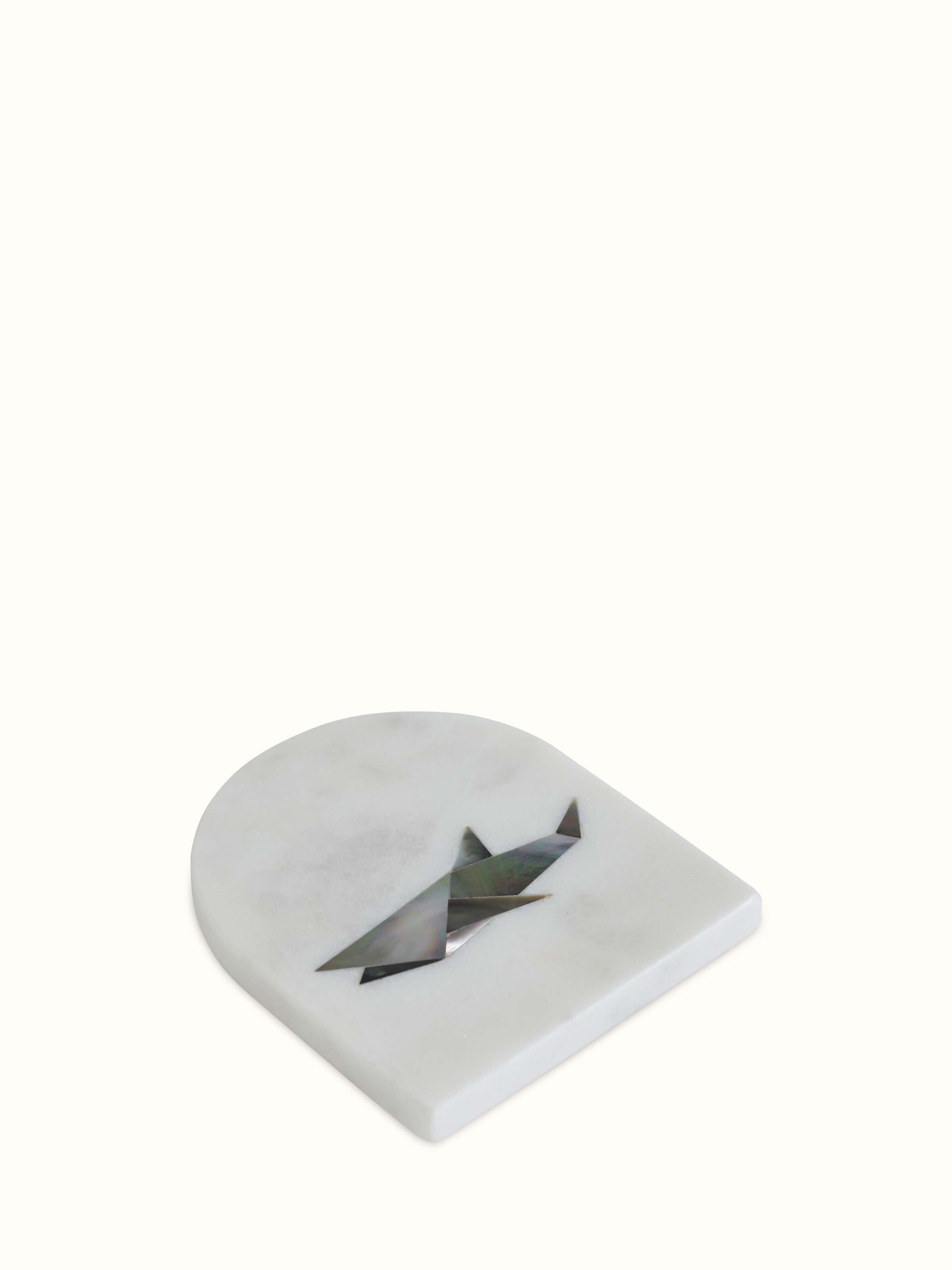 Close-up detail of marble animal carving coaster showing carving depth