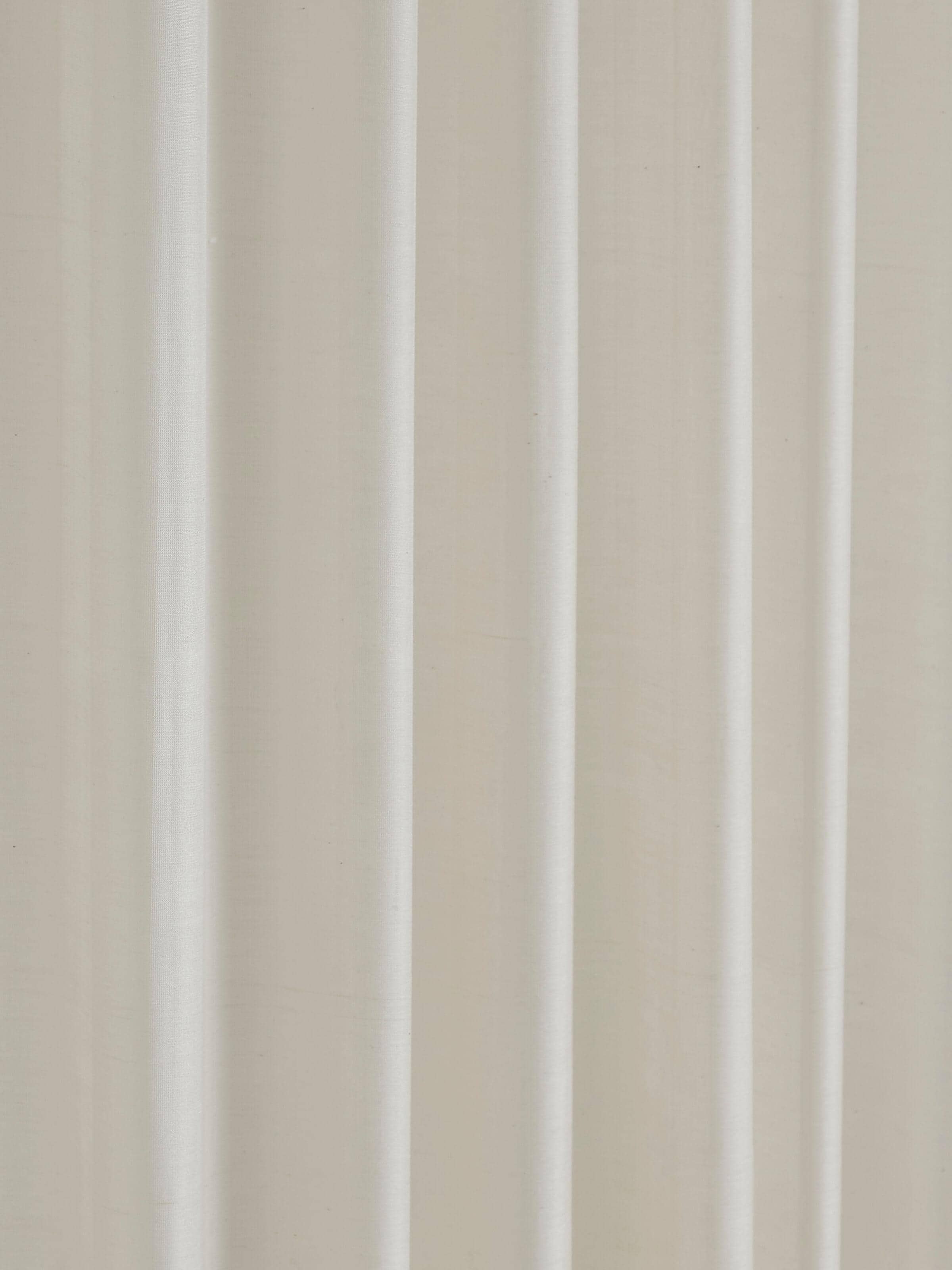 Detail shot of vertical stripe pattern and weave on handloom ivory sheer curtain.