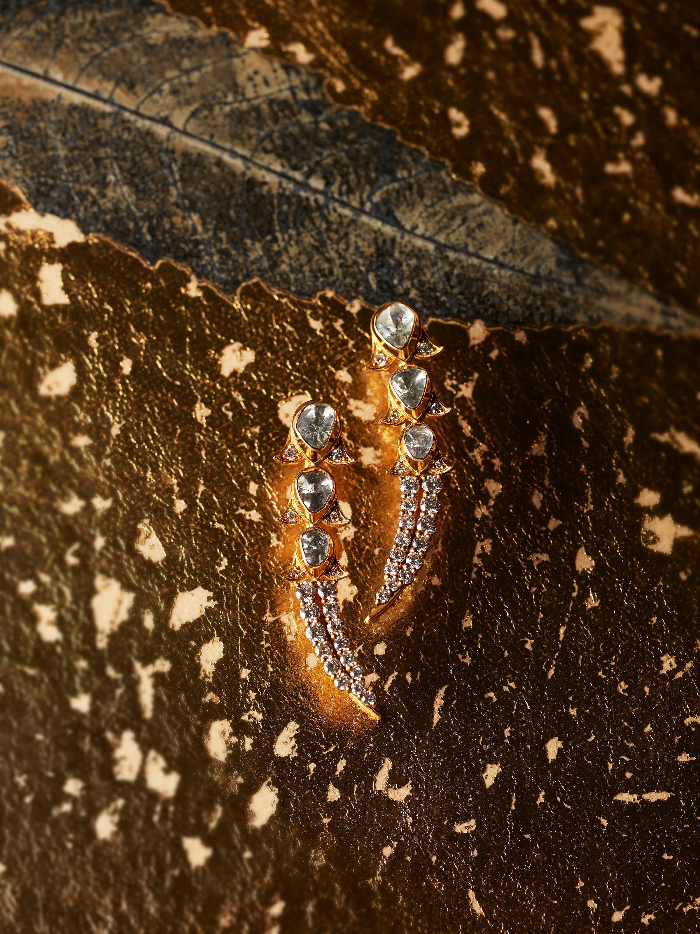 lifestyle view of dank polki 14 karat gold drop earrings