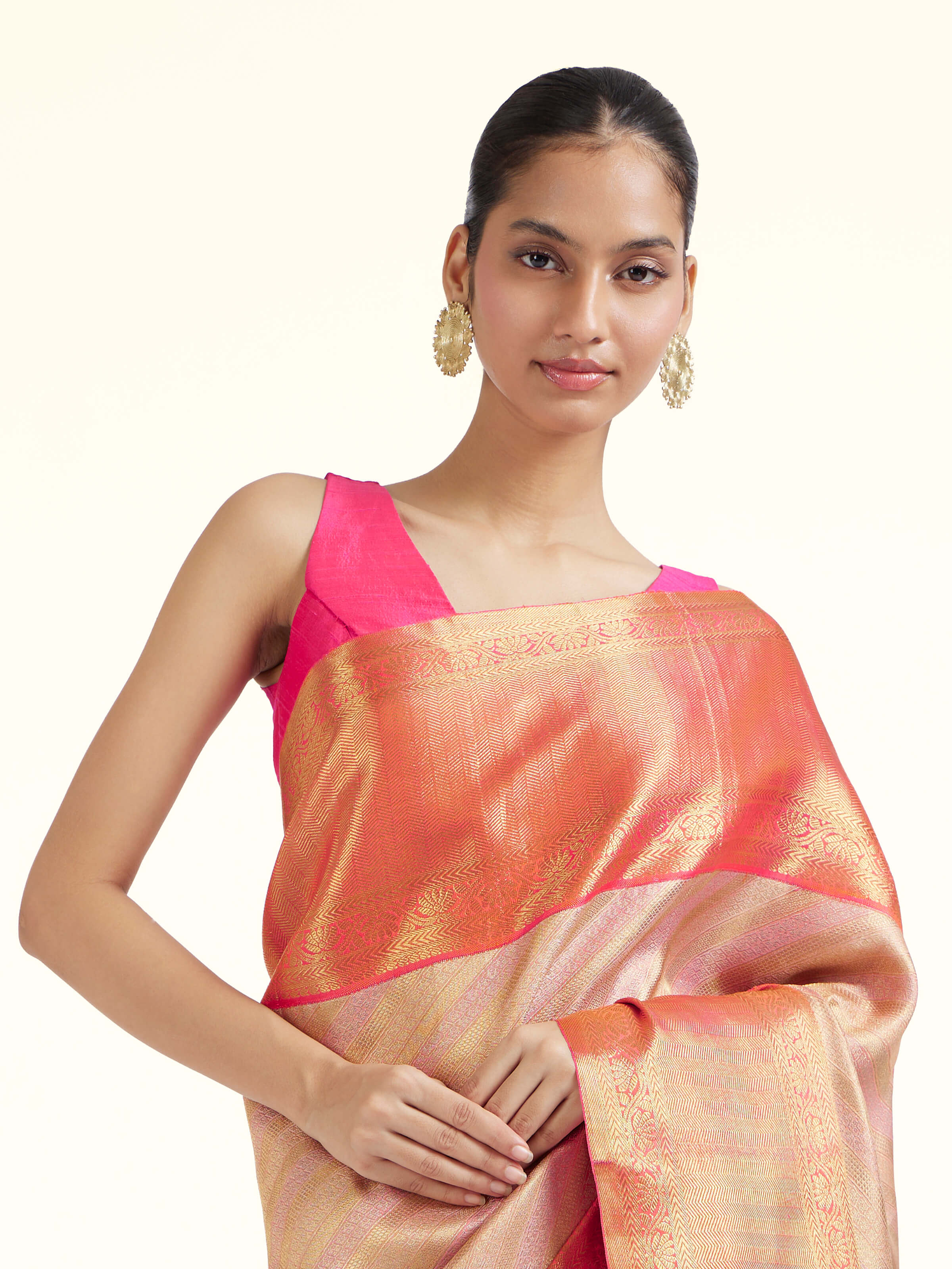 Angled view of light pink silk Kancheepuram saree highlighting traditional weave and soft sheen