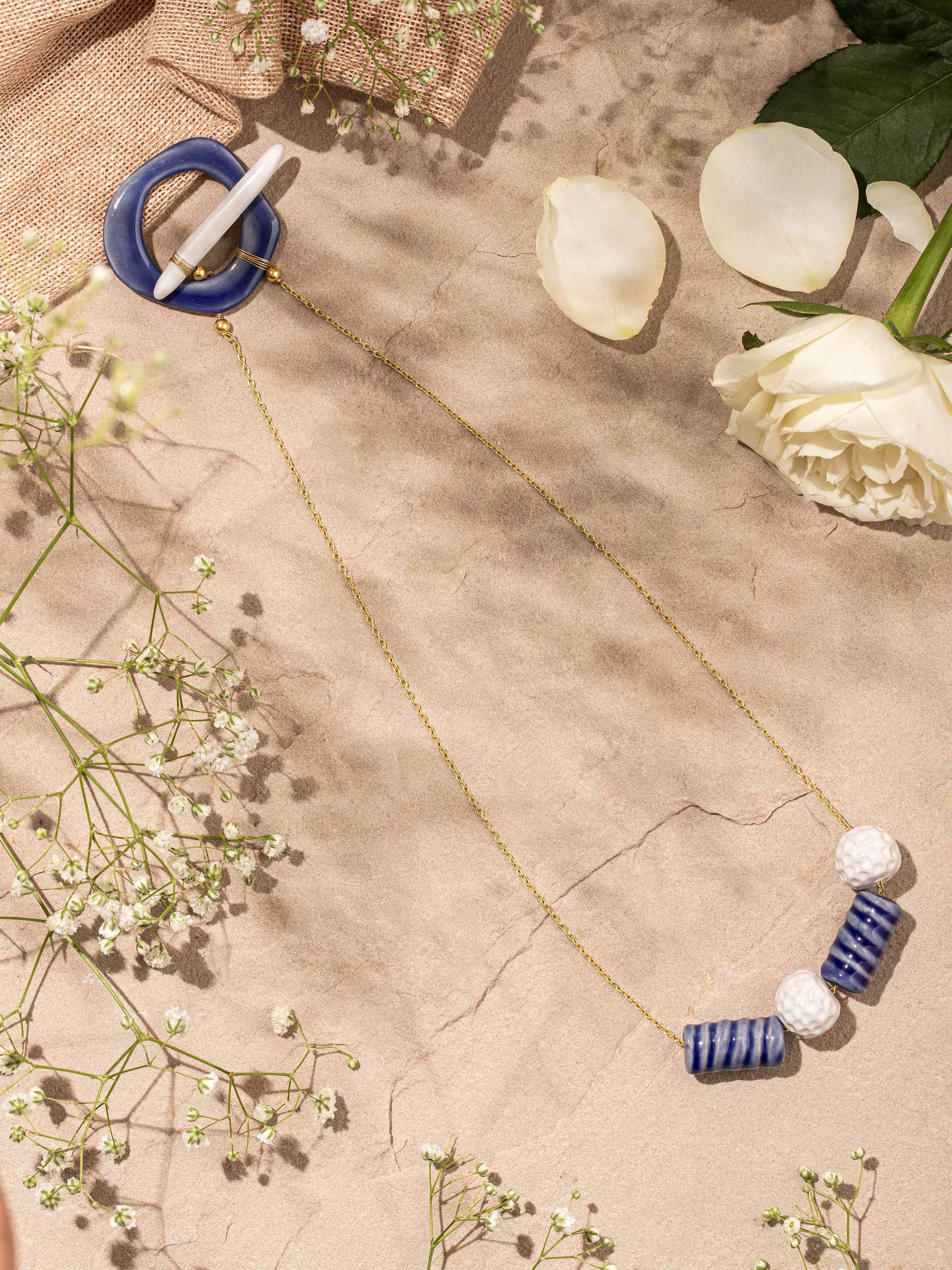 Side angle highlighting texture and colors of ceramic beads in long necklace