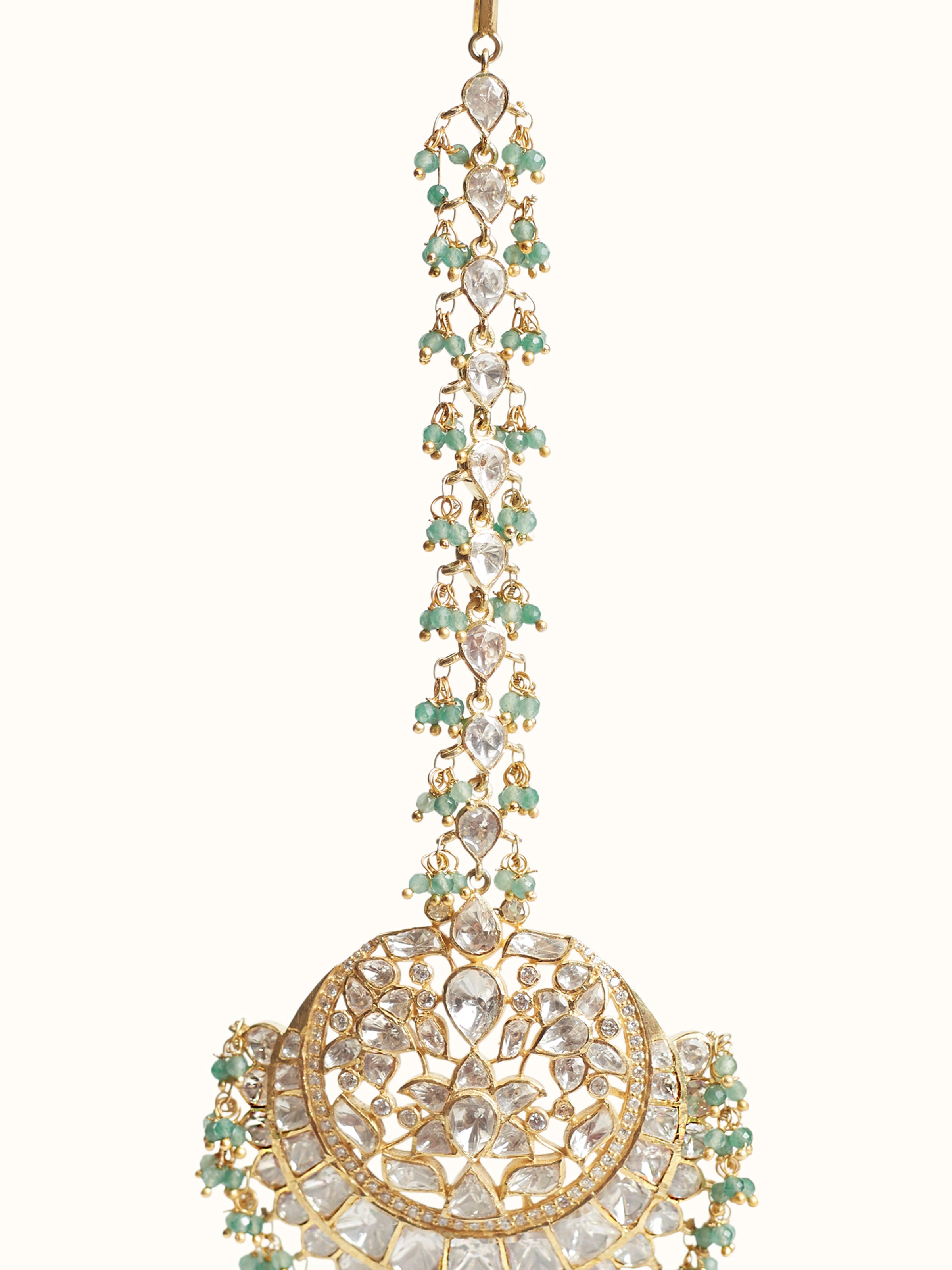 Close-up of silver smithing detail on maang tika