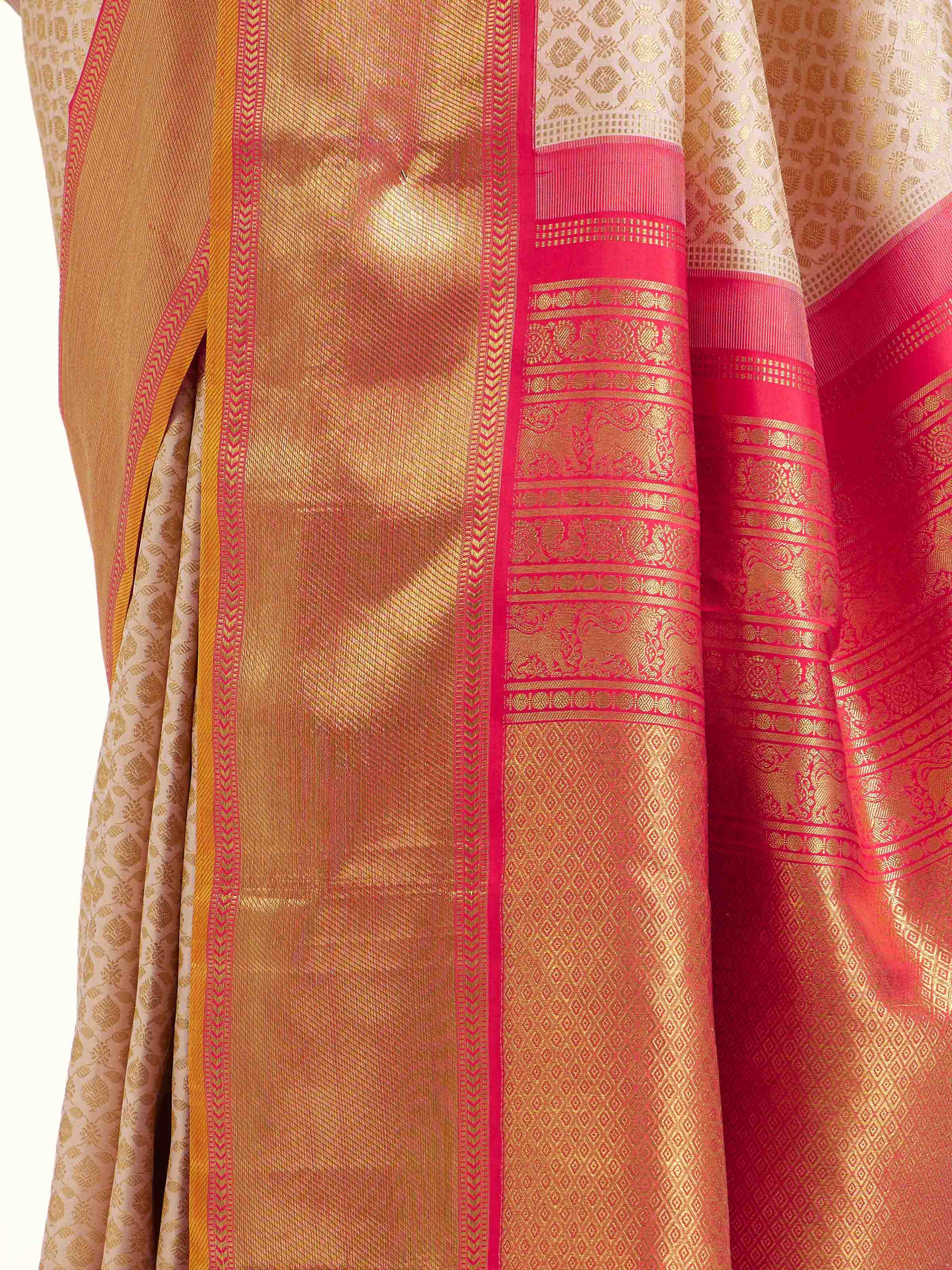 Detail view of onion pink silk Kancheepuram saree showing zari work