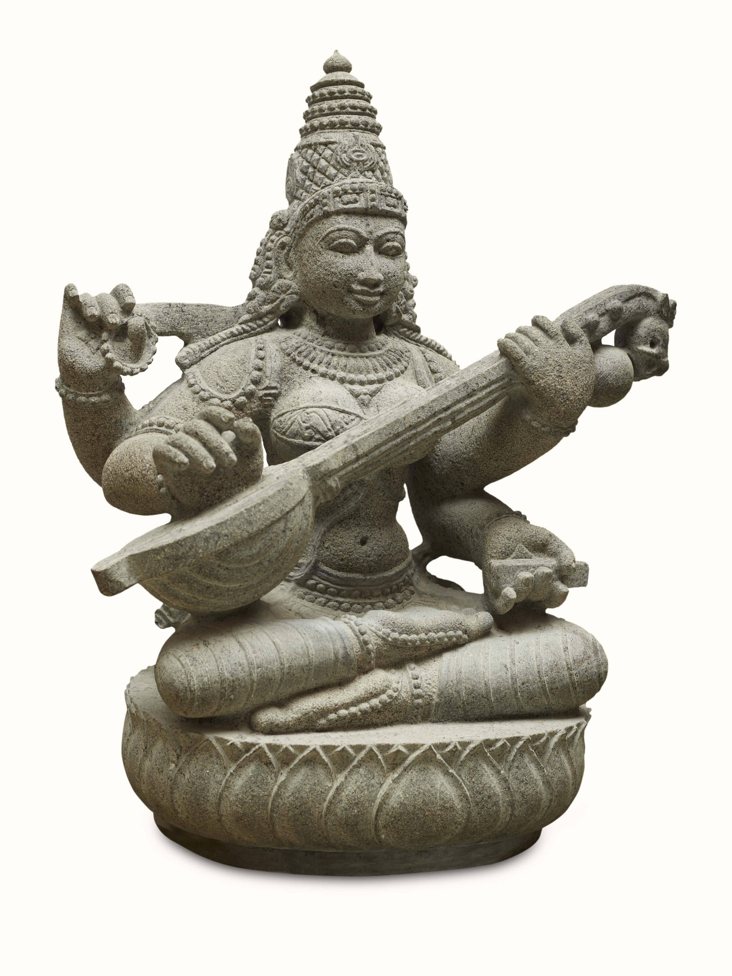 Close-up view of the carved stone goddess Saraswati idol, highlighting intricate details and delicate features.
