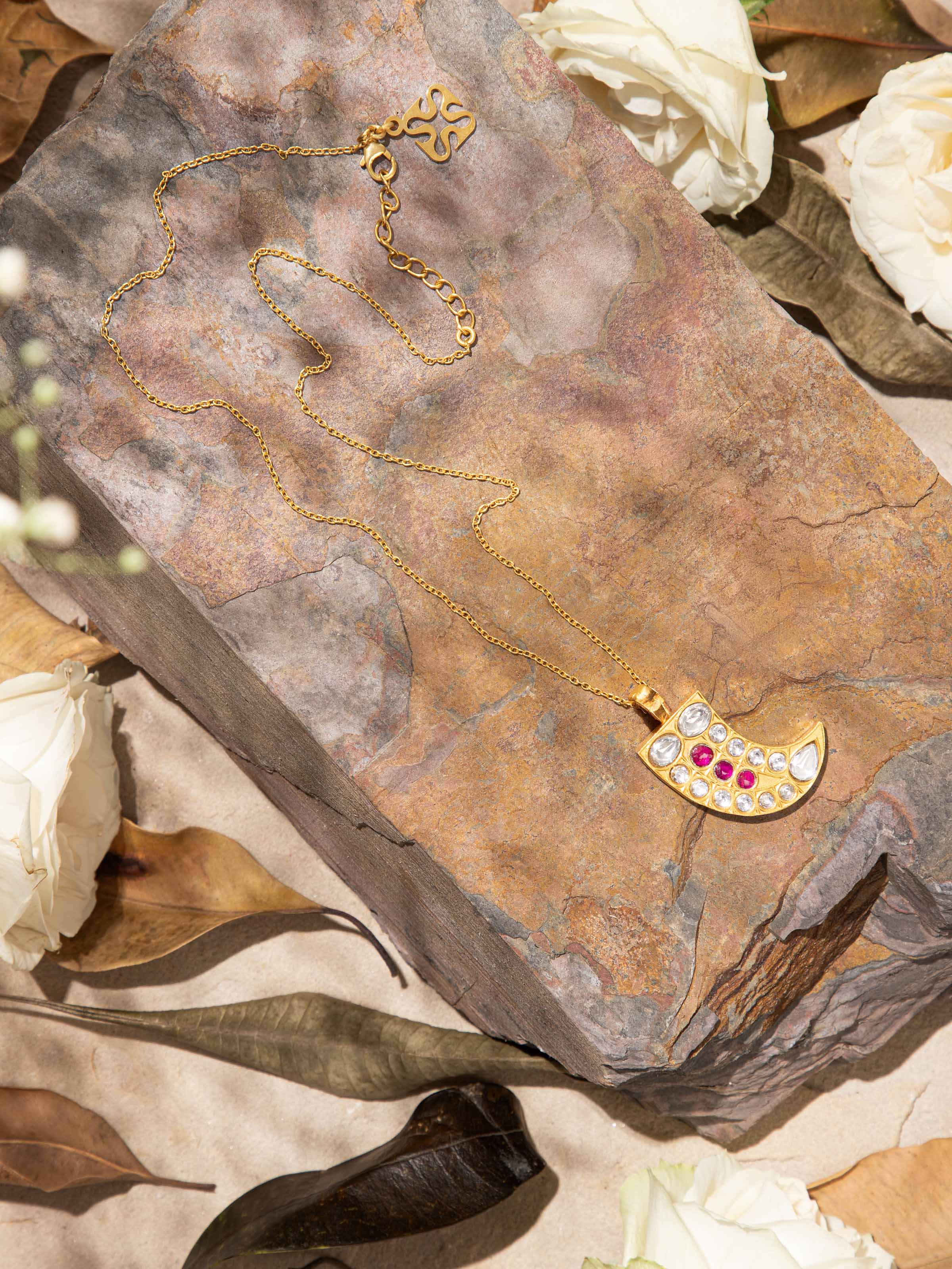 Top view of Silver Smithing pendant on chain, displaying a hammered finish and smooth curved shape.