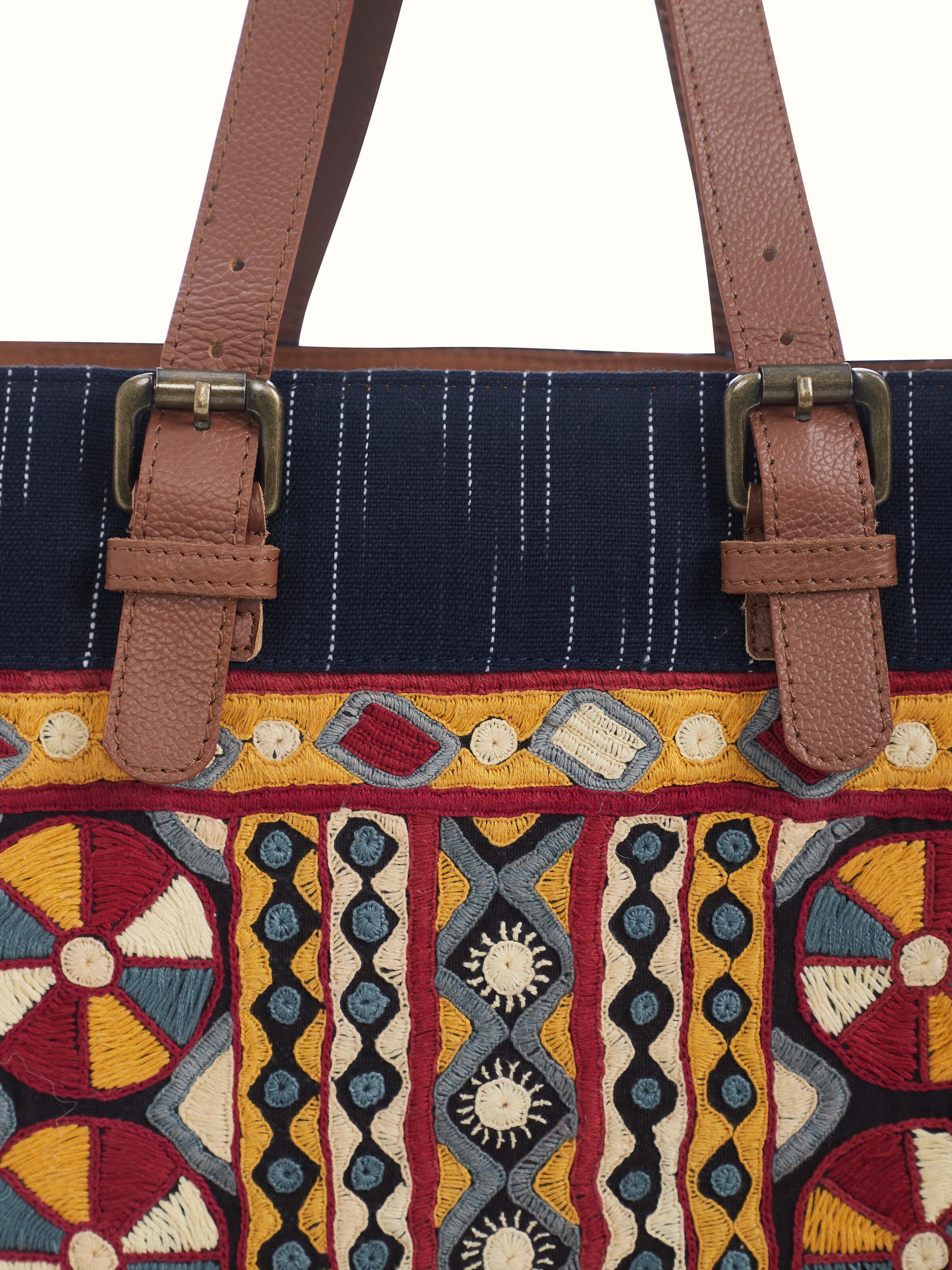 Detail shot of Grey Leather & Textile Embroidered Tote Bag showcasing artisan embroidery on fabric panel.