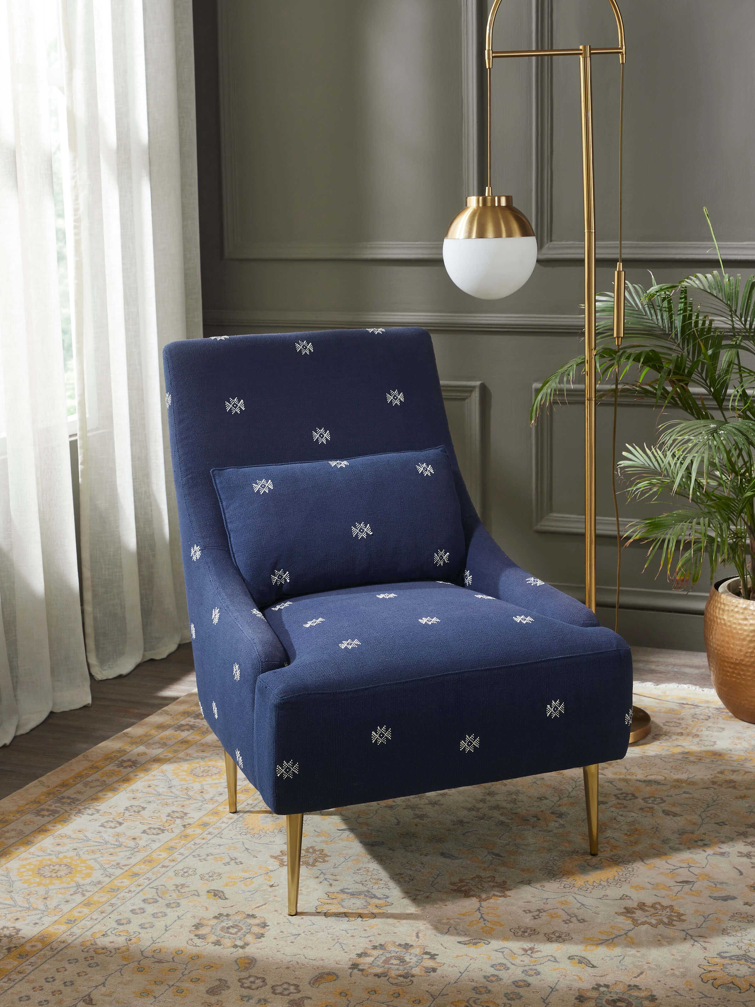 Side view of Upholstered Metal Wing Chair, showcasing its sleek design and sturdy metal frame