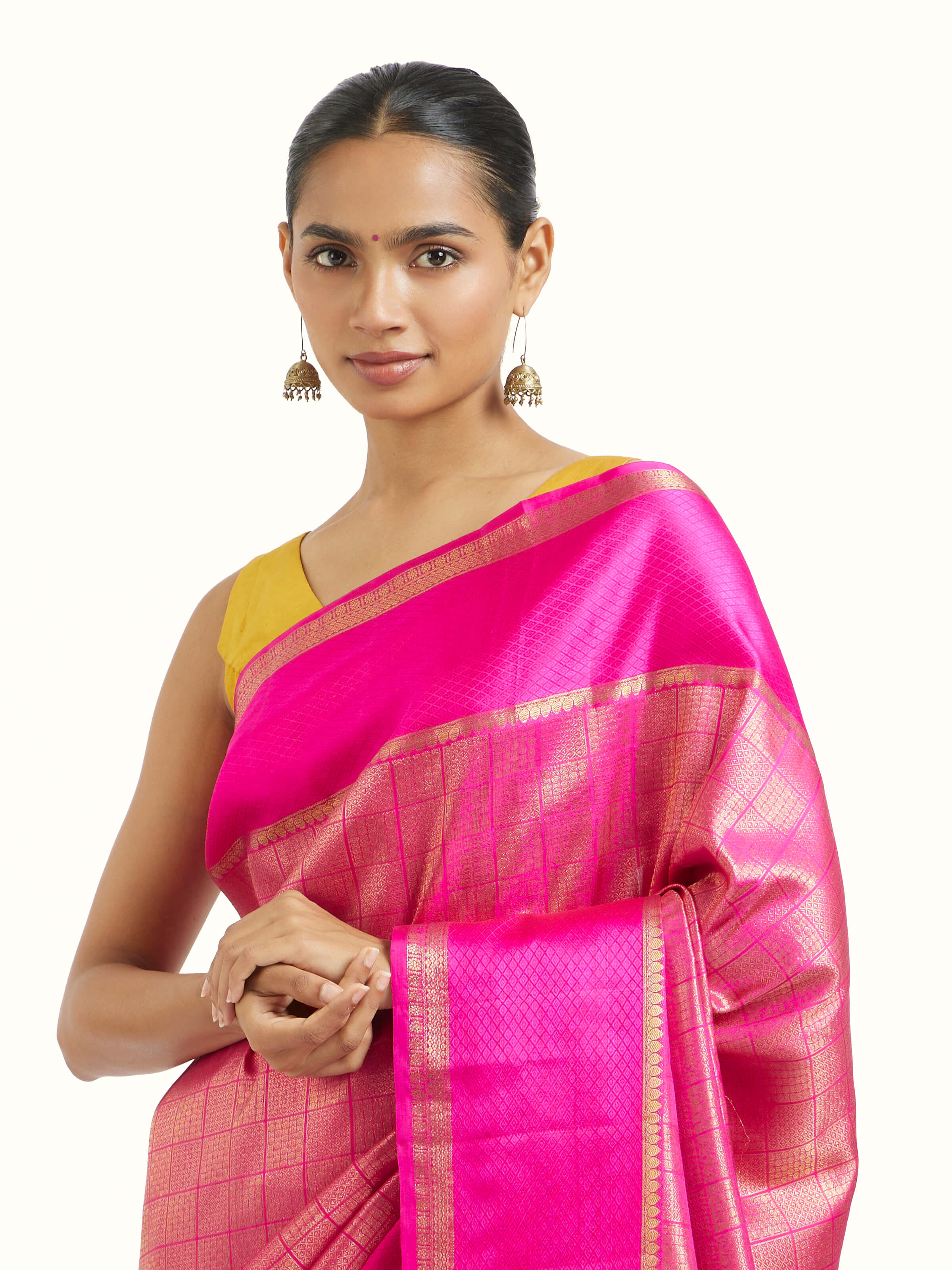 Angled view of pink silk Kancheepuram saree highlighting traditional weave and sheen