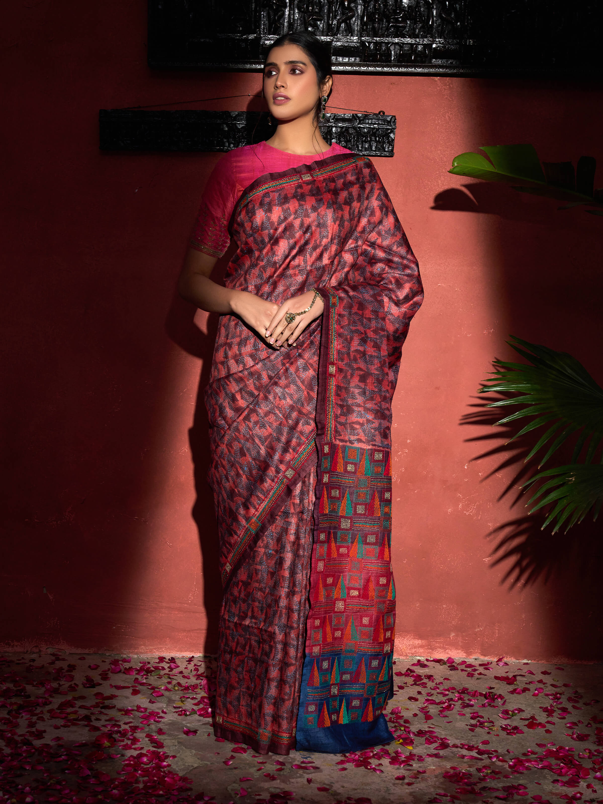 Side view of red tussar silk discharge printed Kantha embroidered saree highlighting drape