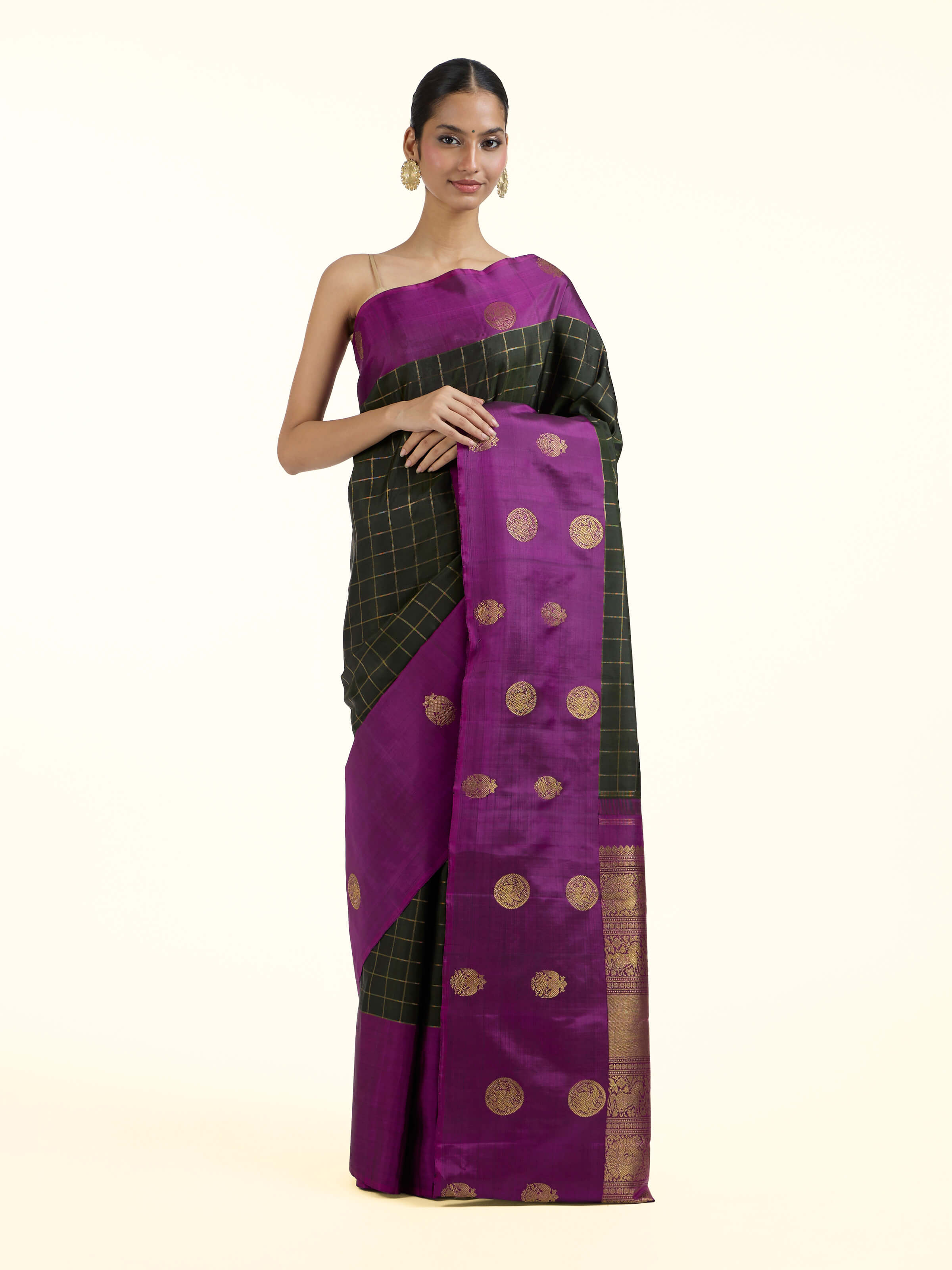 Front view of black silk Kancheepuram saree showcasing rich zari motifs