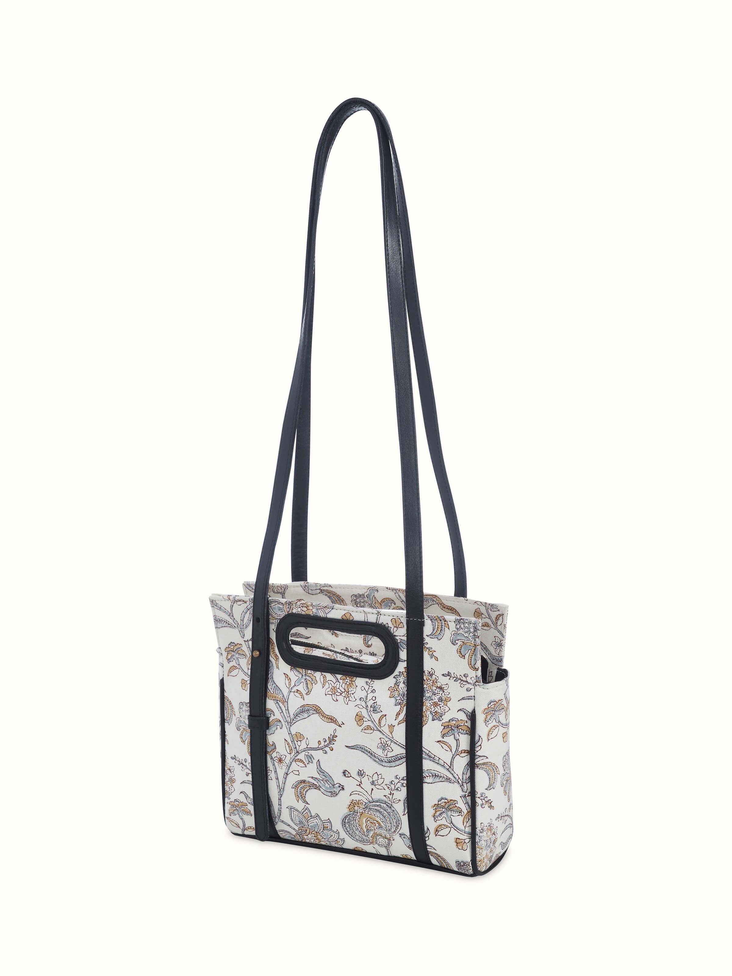 Angled shot emphasizing hand block patterns and structured silhouette.