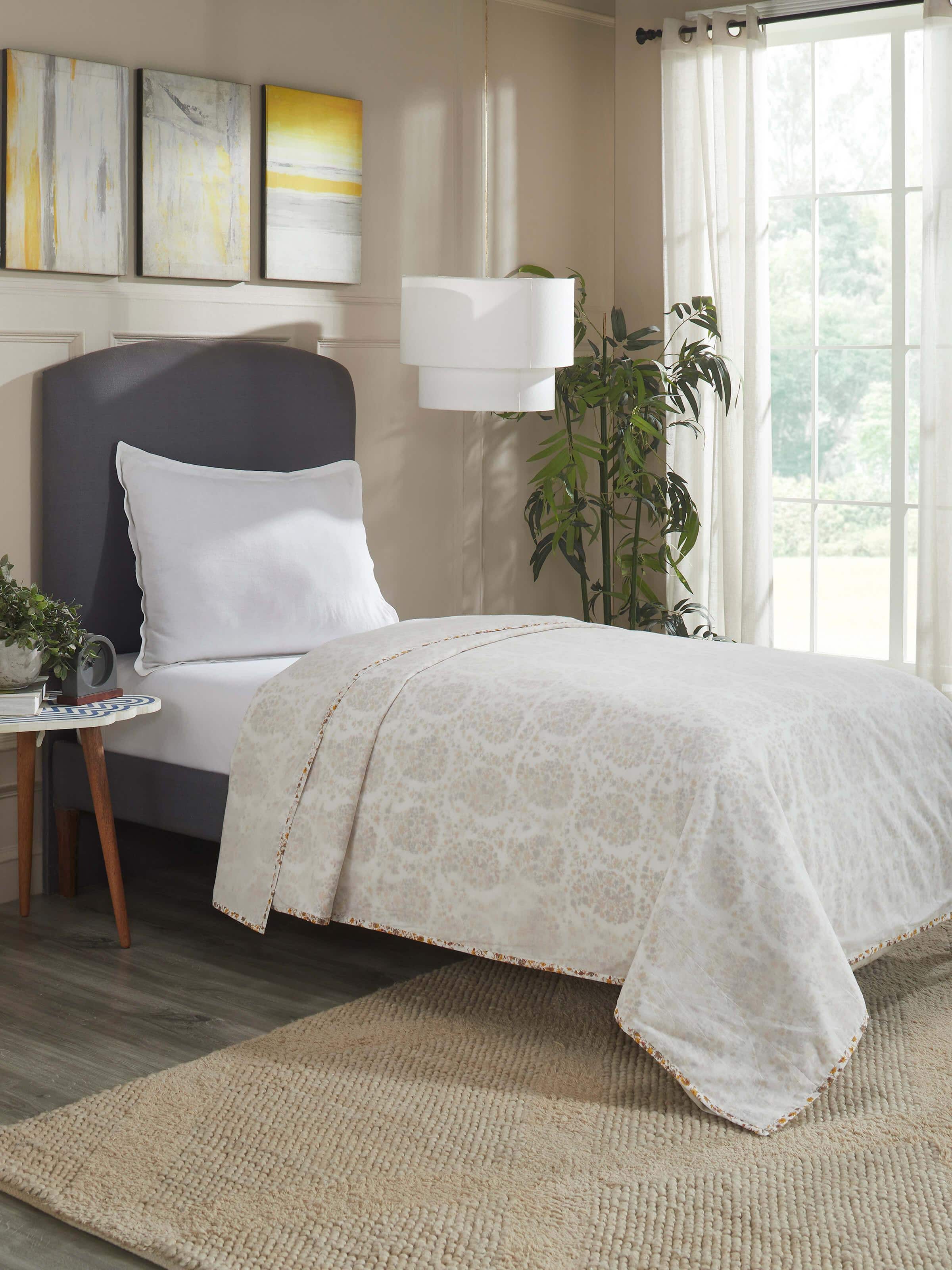 Lifestyle view of red Sanganeri hand block printed cotton single dohar on bed.