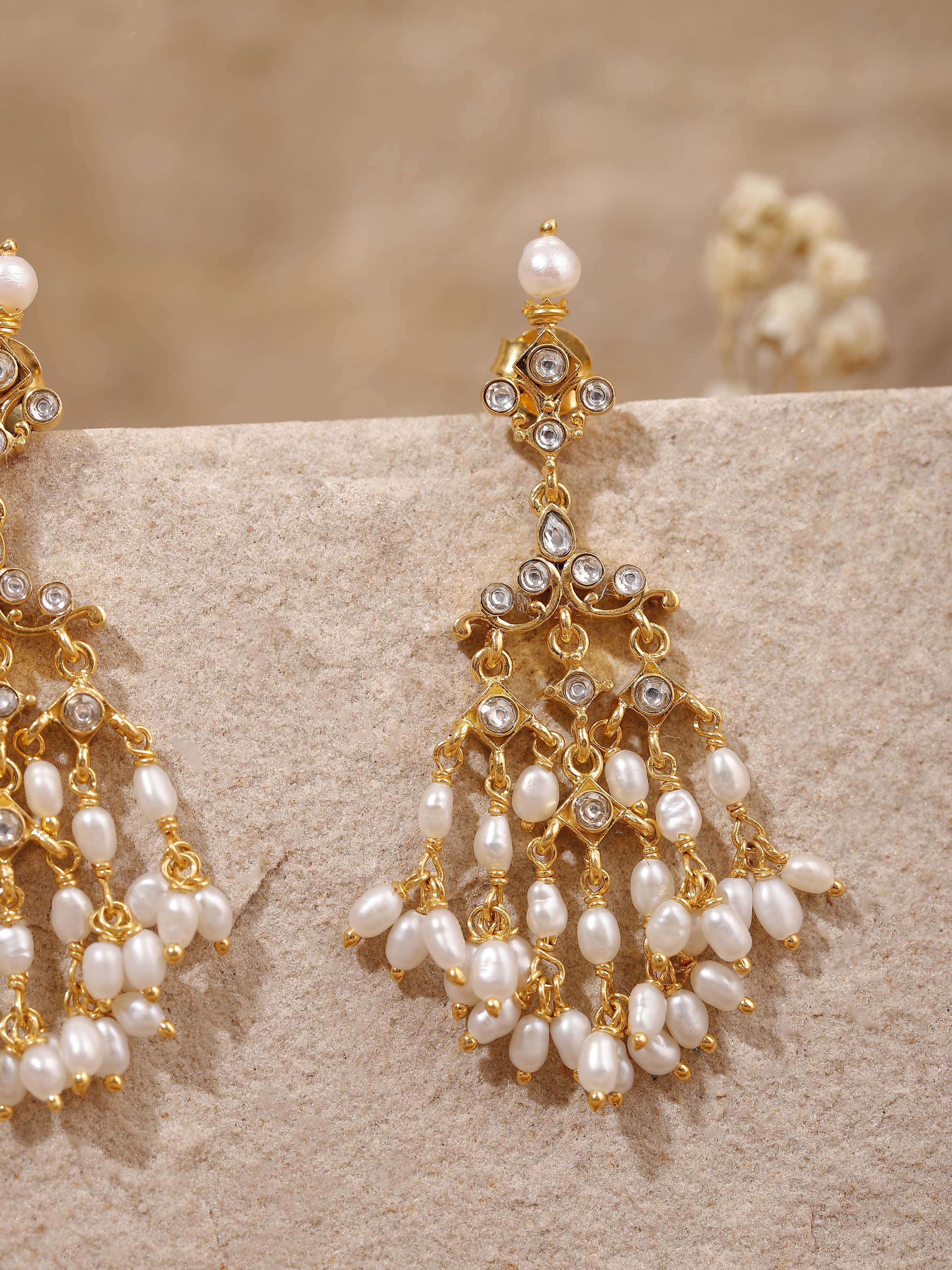 Overhead view offering a balanced composition of silverwork and pearls in the earring design.