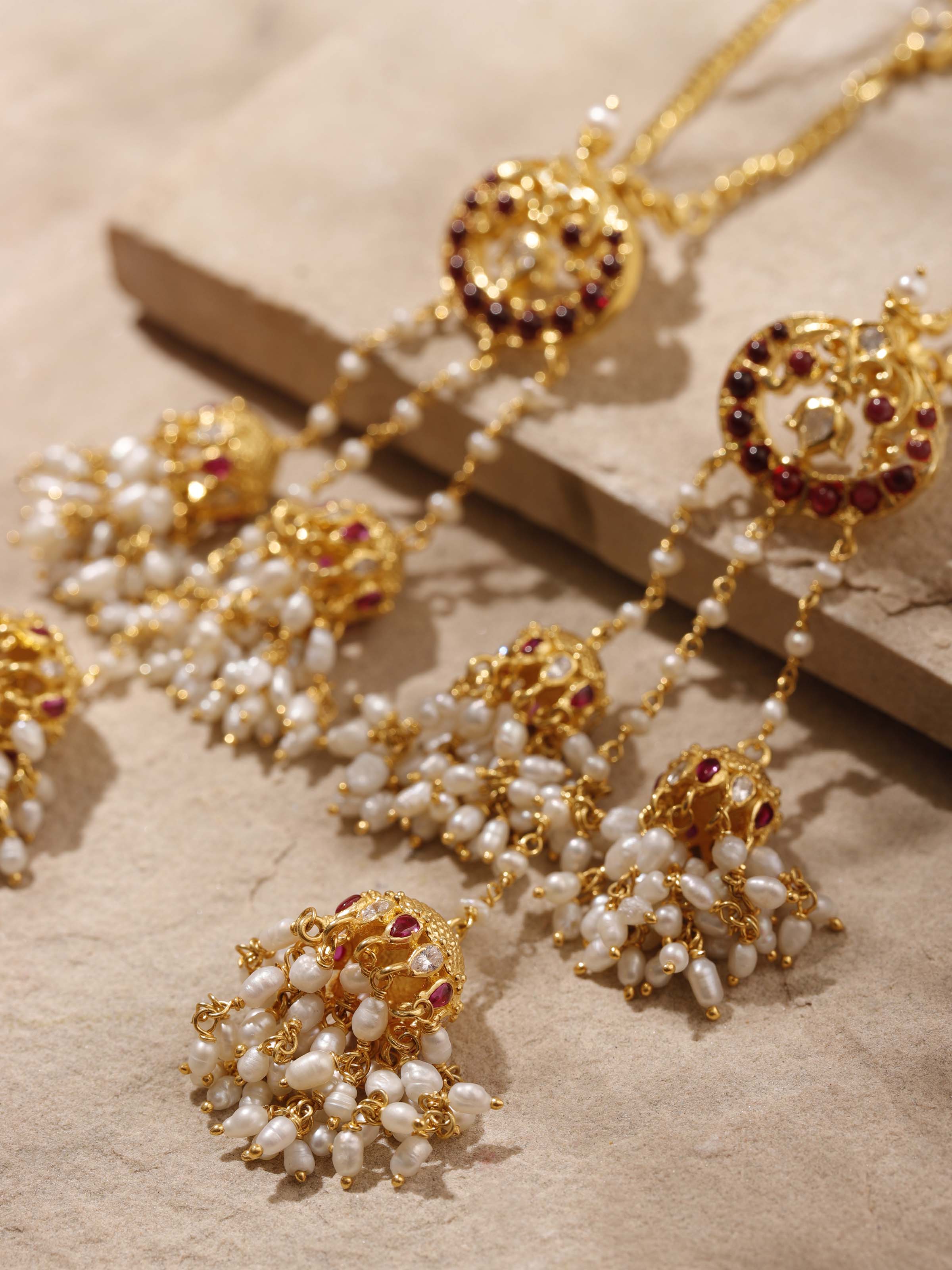 Detailed view of Guttapusalu silver drop earrings displaying intricate floral patterns and beadwork