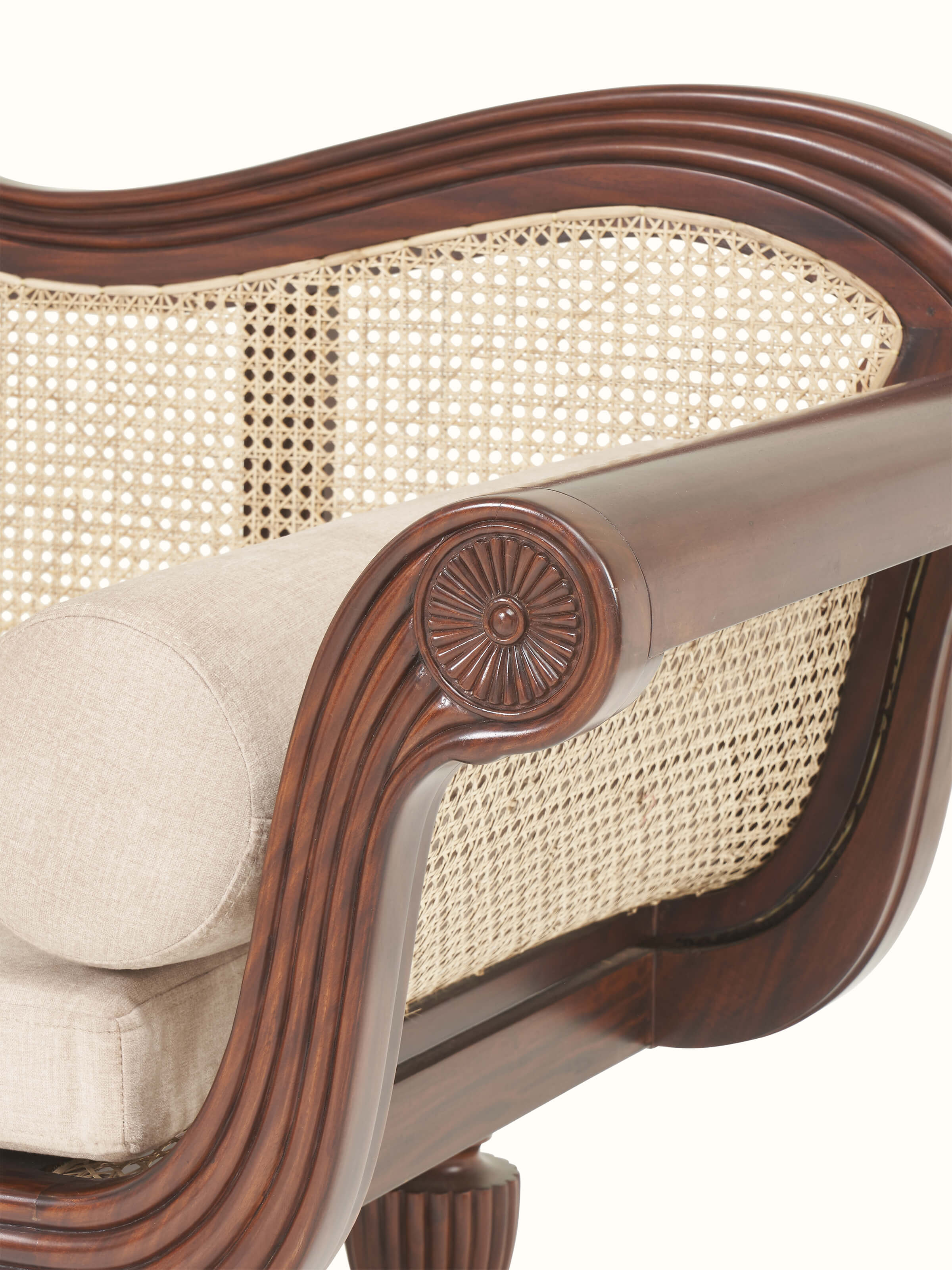 Detailed view of upholstered Mahogany wood and cane sofa highlighting cane paneling and soft upholstery