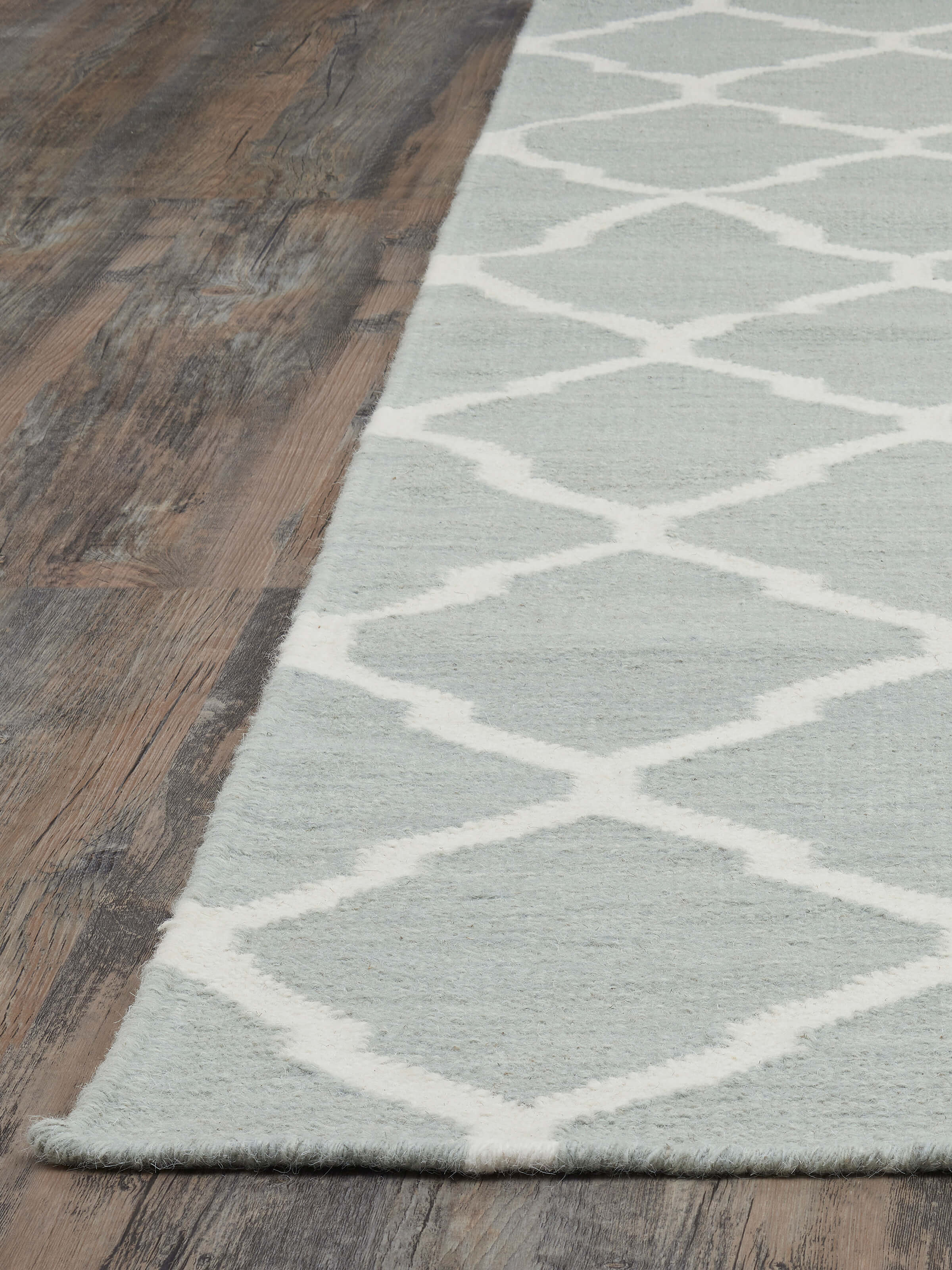 Angled close-up revealing the texture and intricate wool weave of the Panja dhurrie