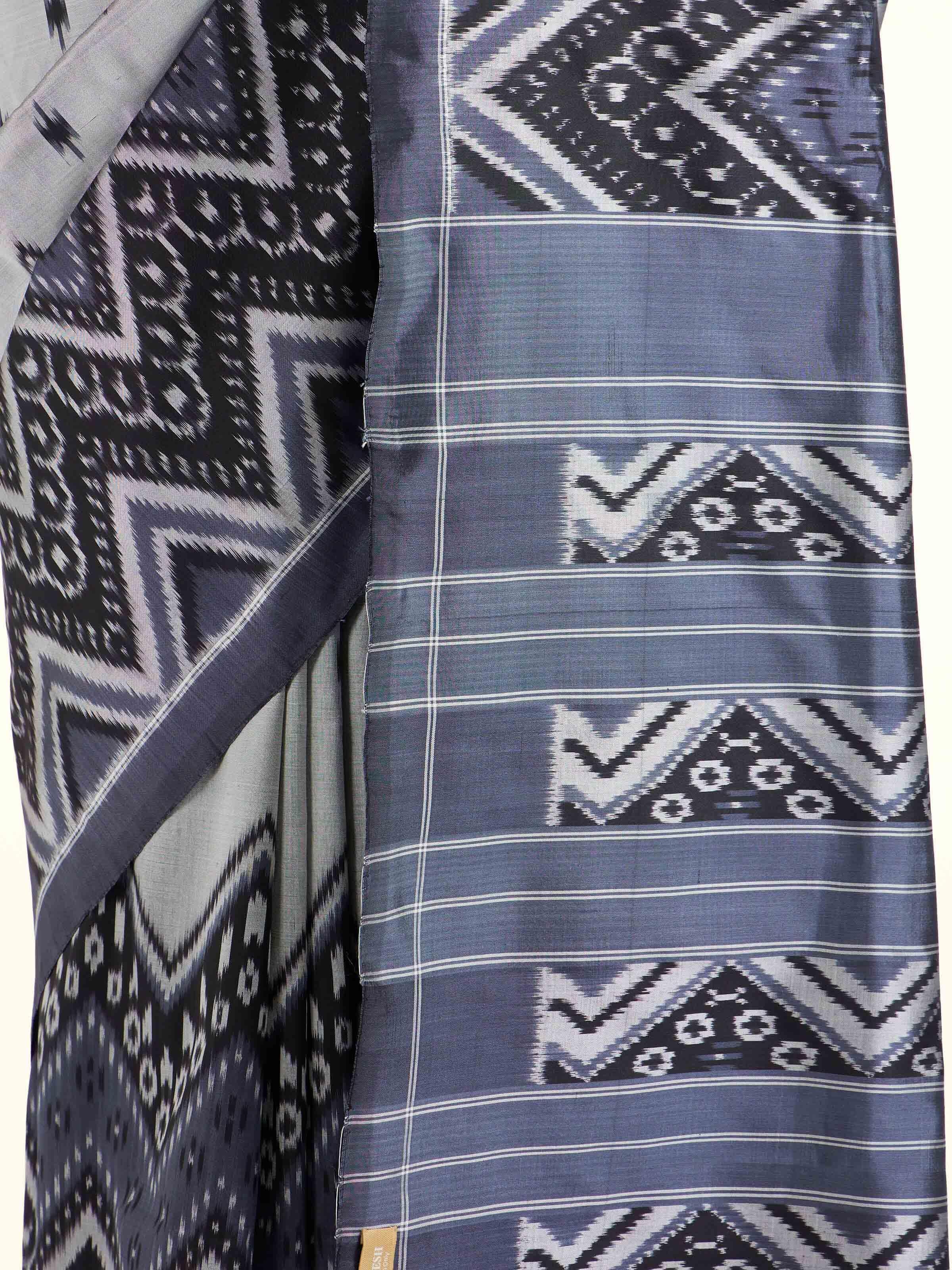 Detail view of off-white mulberry silk ikat saree showing craftsmanship