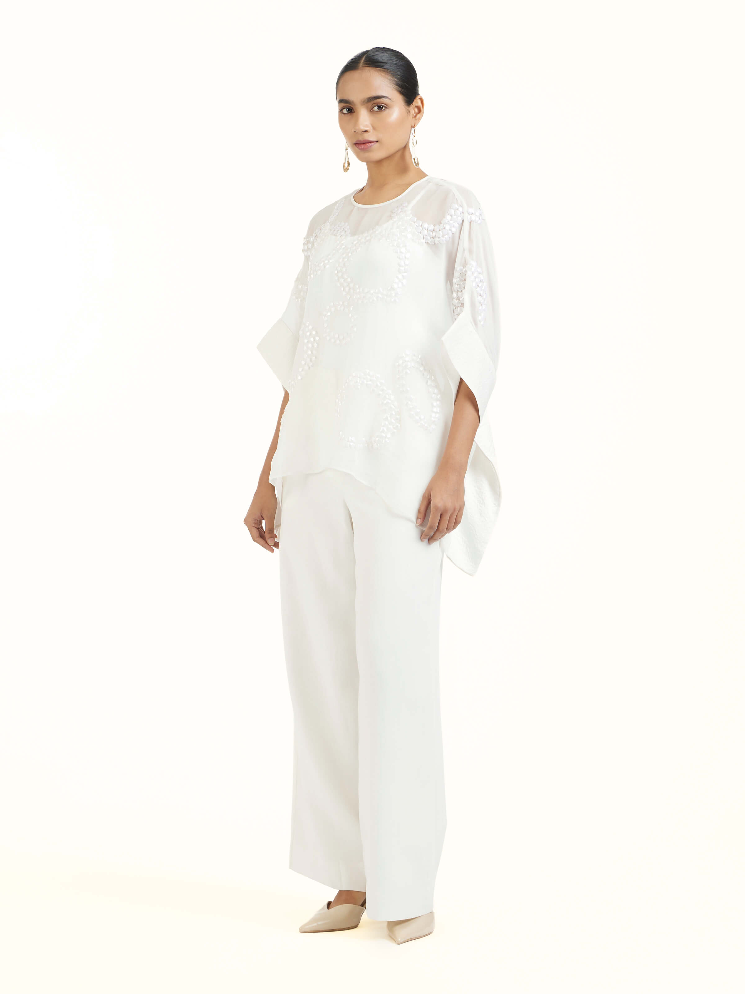 Side view of ivory hand embroidered organza kaftan highlighting airy drape and graceful flow