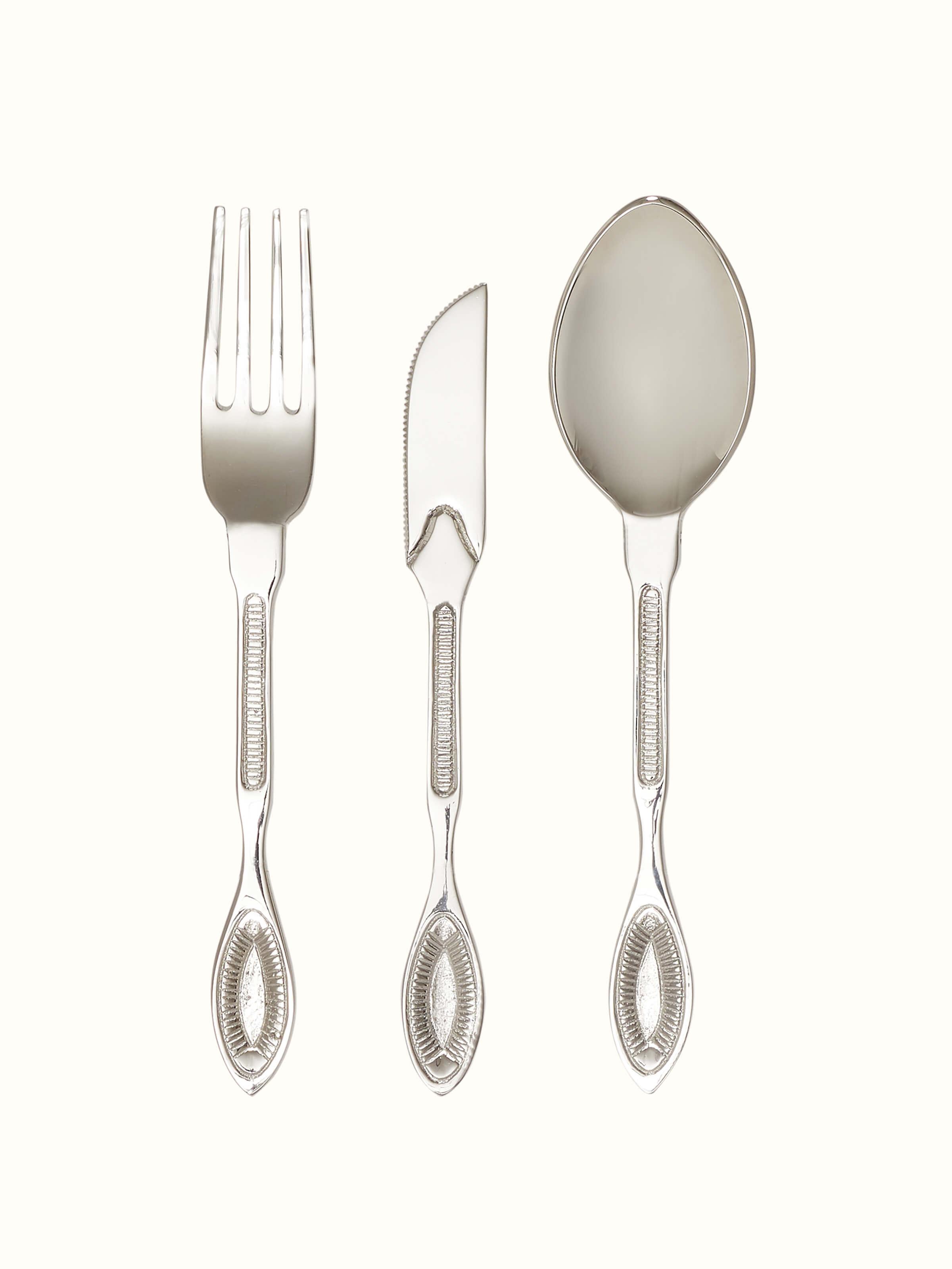 Front view of Nakkashi brass cutlery set with intricate design