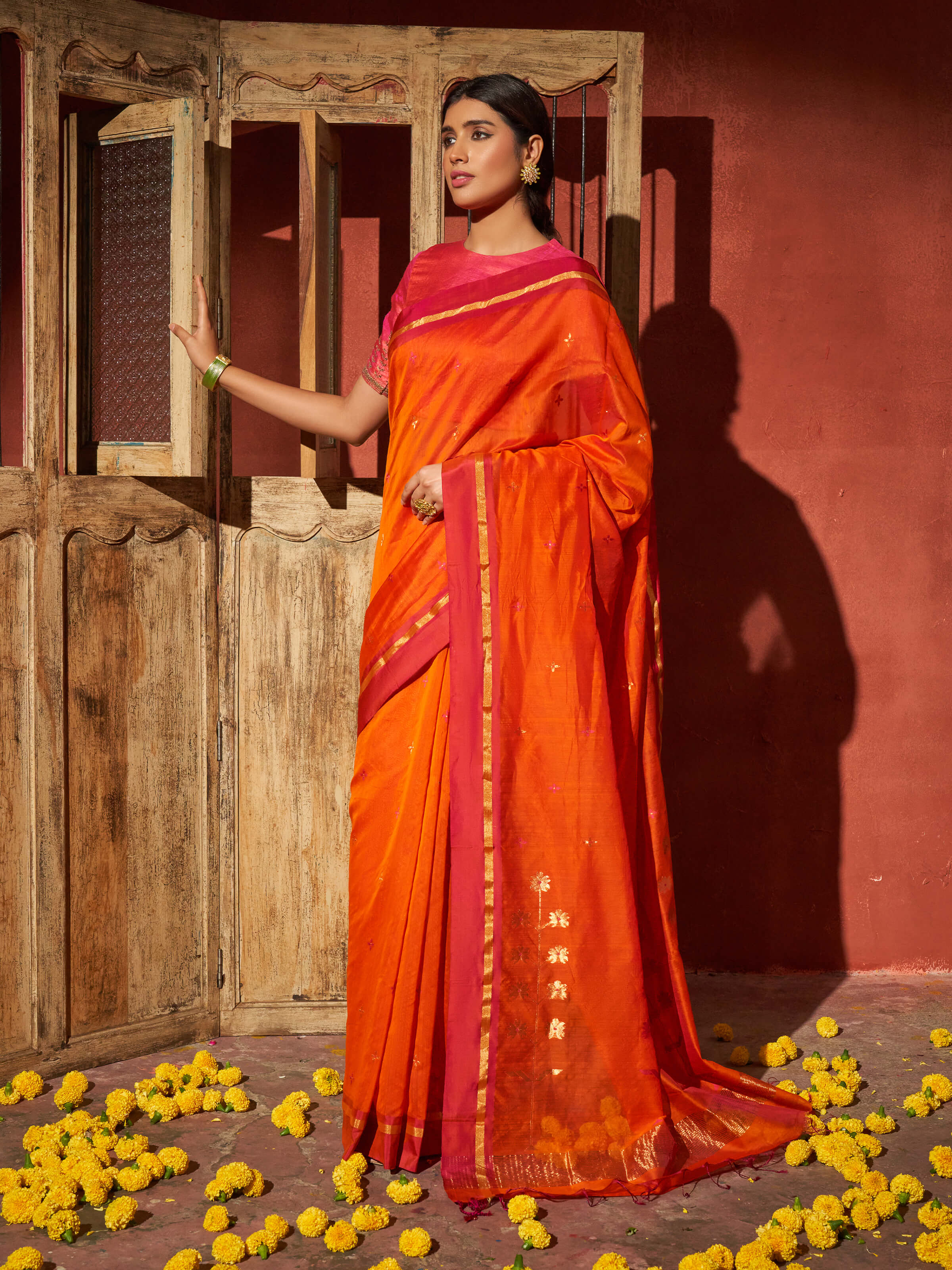 Side view of rust mulberry silk cotton Chanderi saree highlighting graceful drape