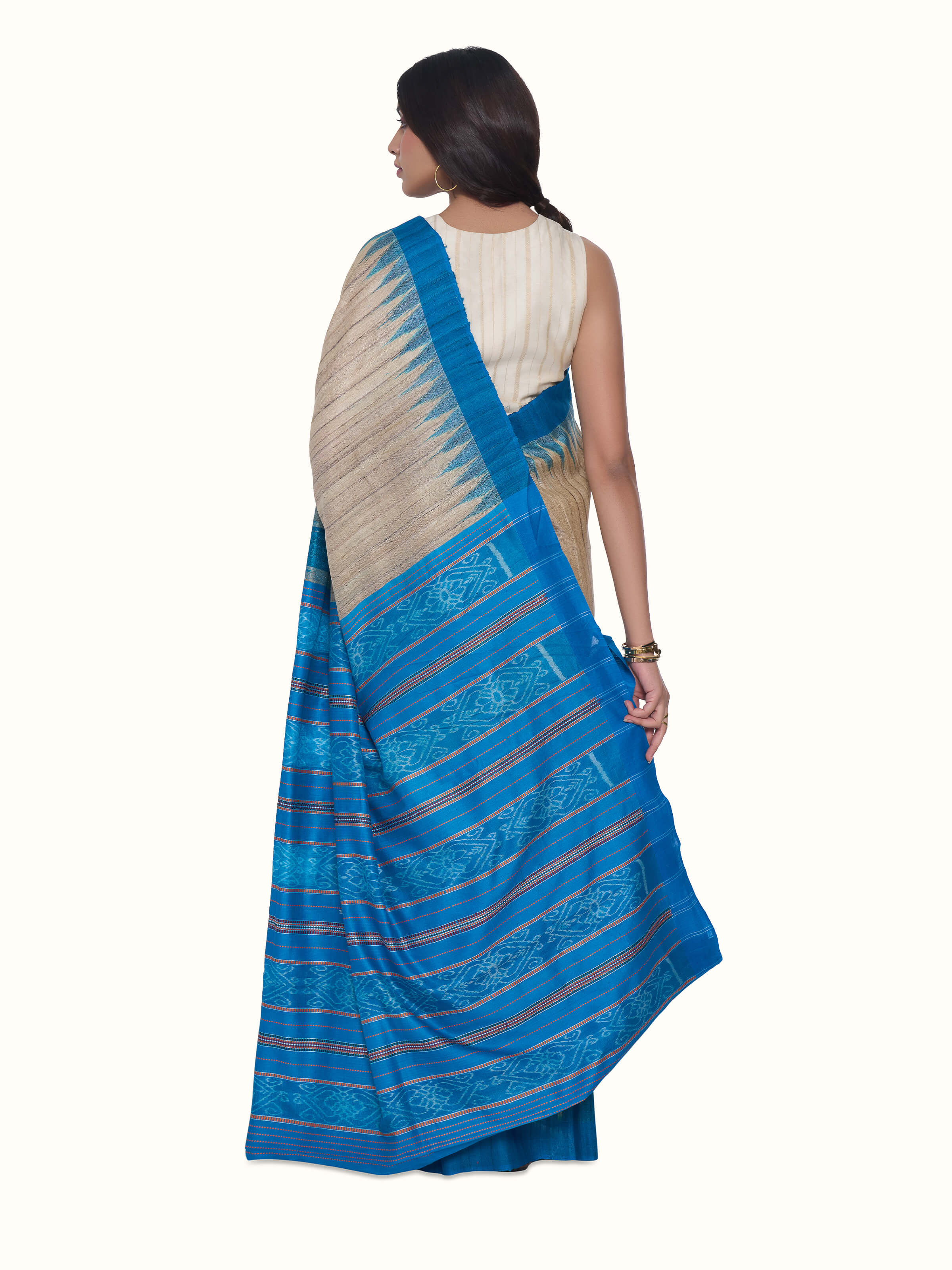 Back view of turquoise tussar ghicha silk Bandha ikat saree with decorative pallu