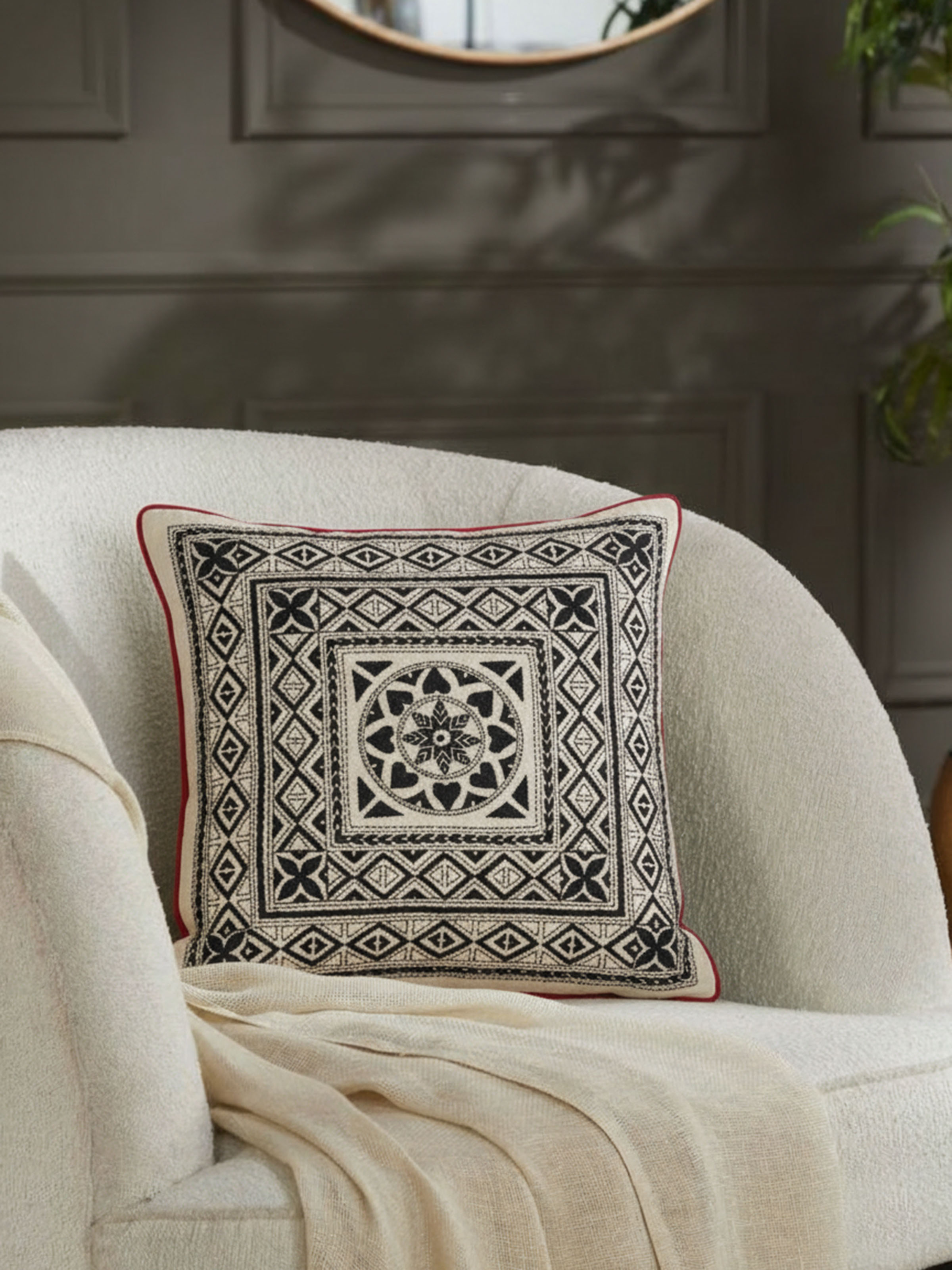 Riten black Kantha embroidered cushion cover styled on sofa