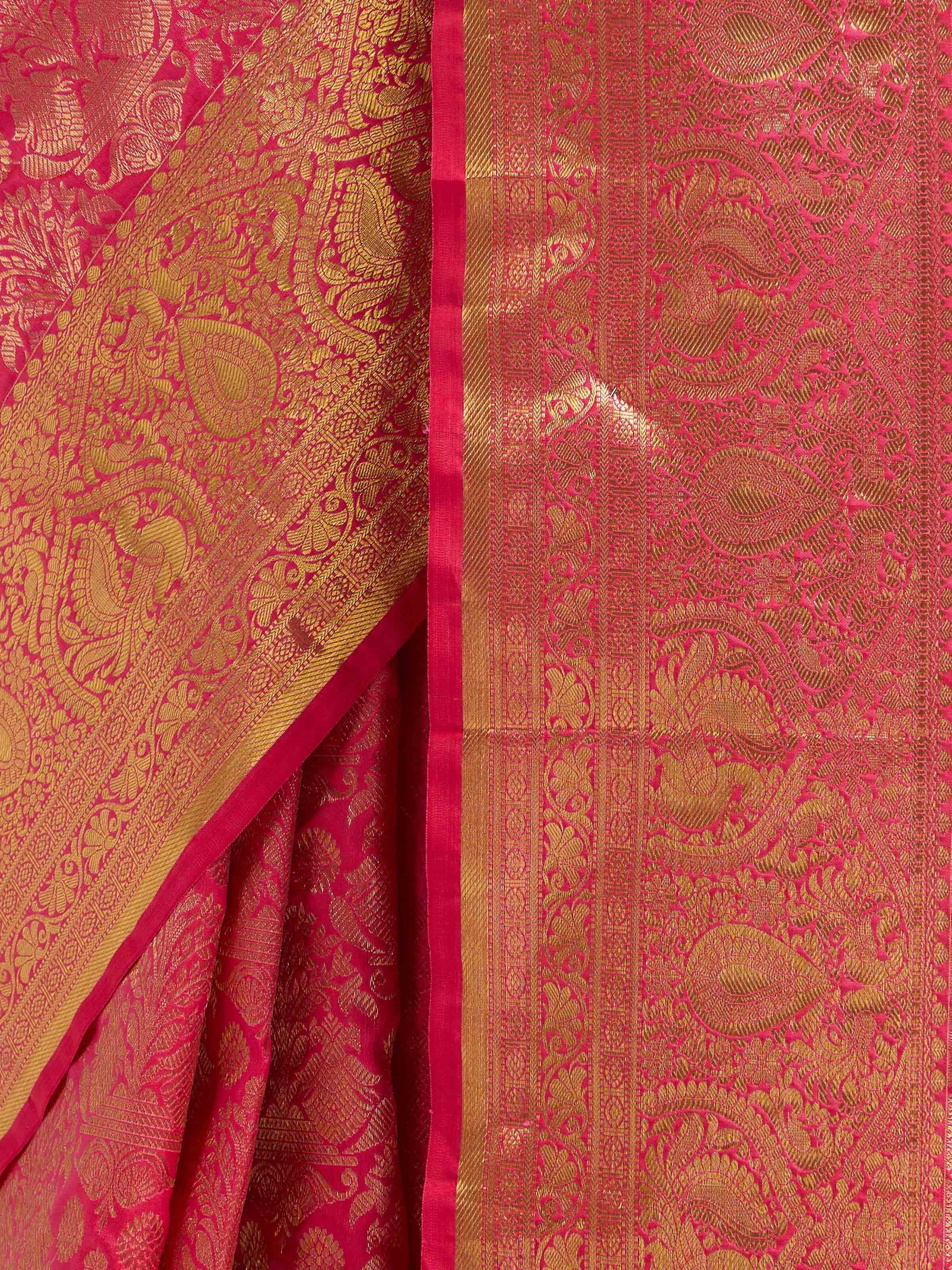 Detail view of red silk Kancheepuram saree showing silk texture and intricate zari work