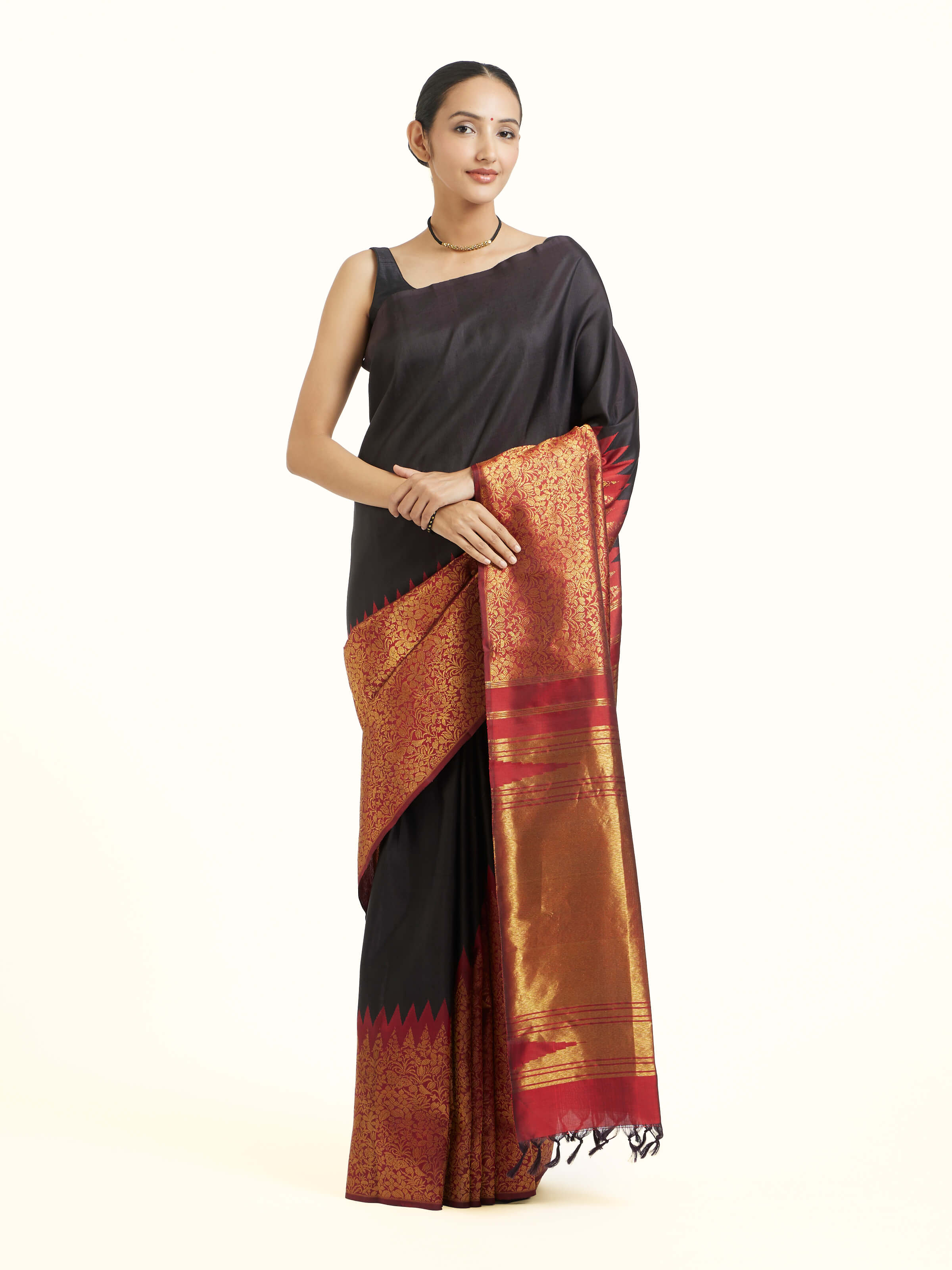 Front view of black silk Kancheepuram saree with rich zari woven motifs
