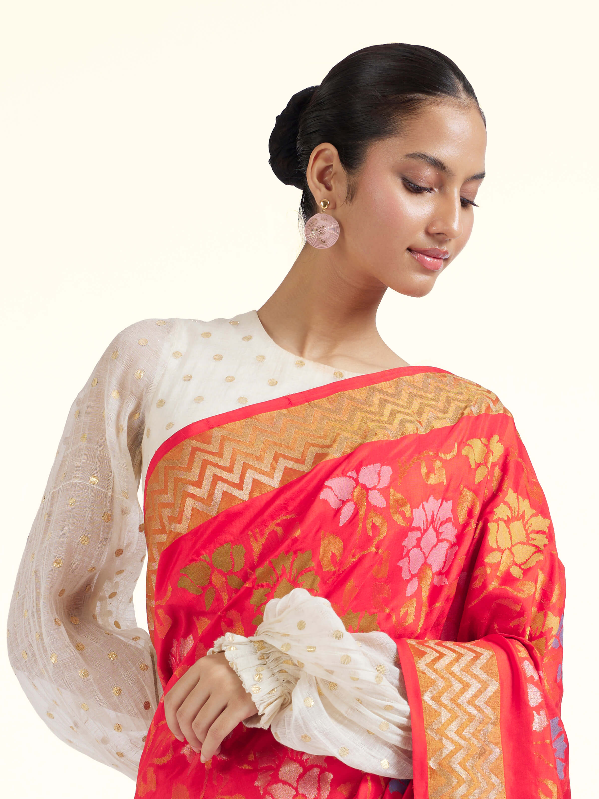 Angled view of red mulberry silk Uppada Jamdani saree emphasizing woven details