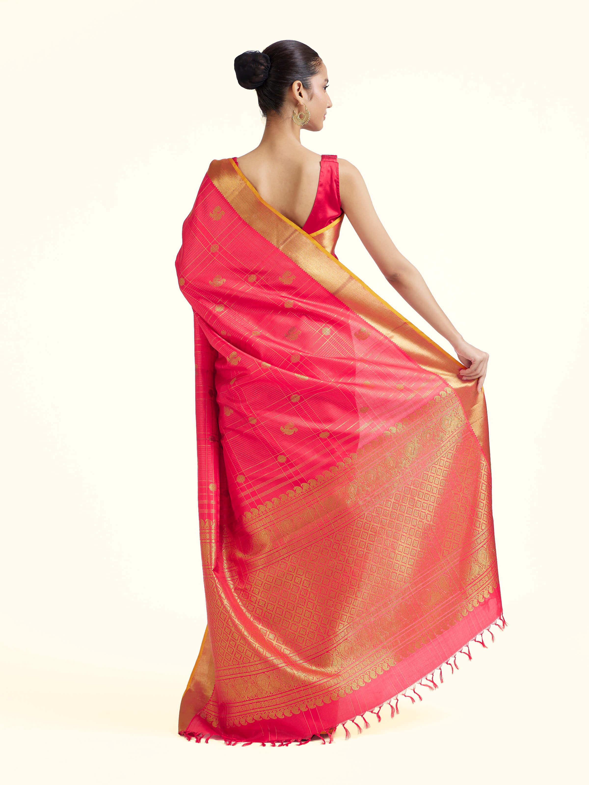 Back view of red silk Kancheepuram saree displaying ornate pallu design