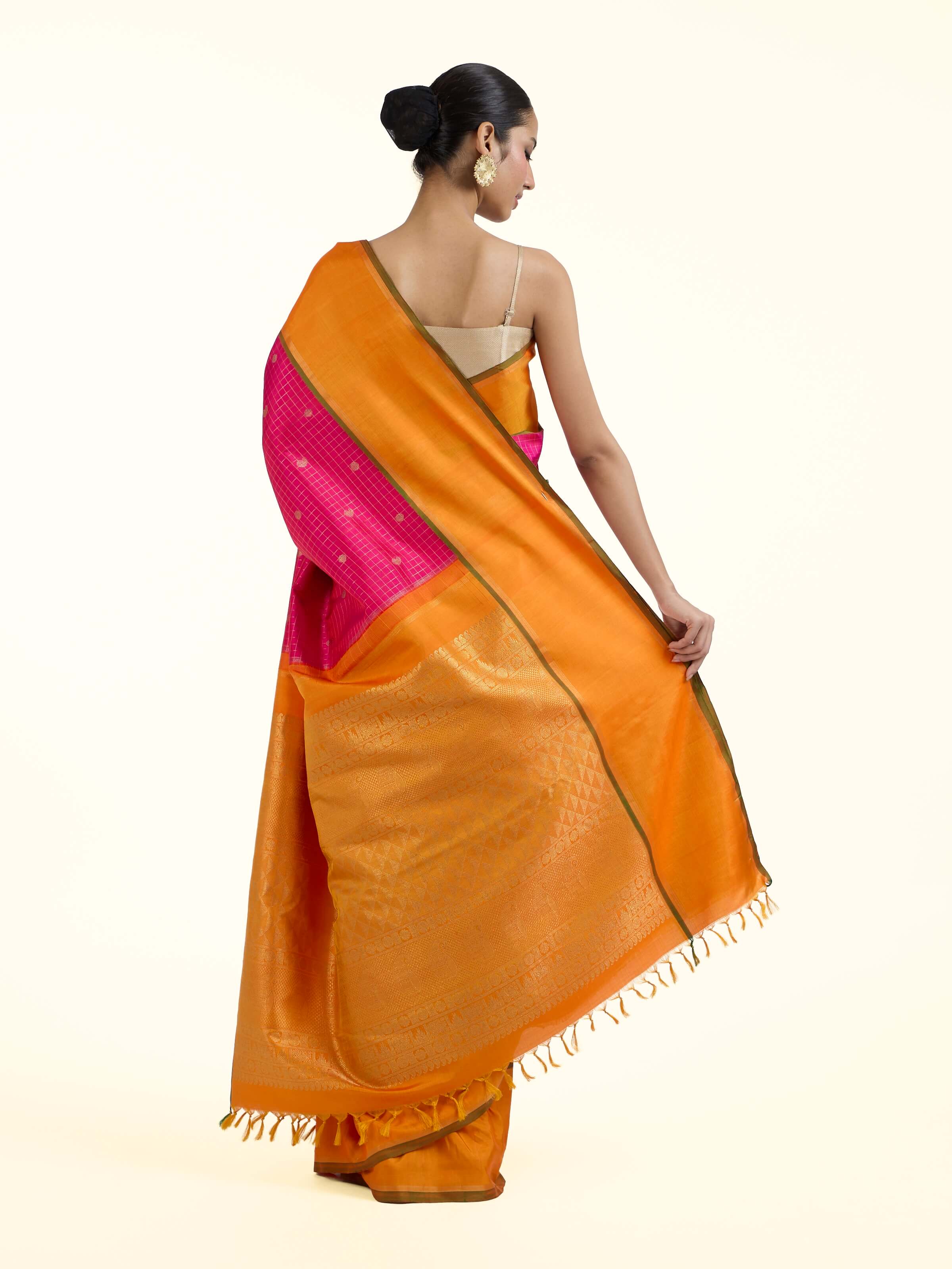 Back view of pink silk Kancheepuram saree displaying ornate pallu design