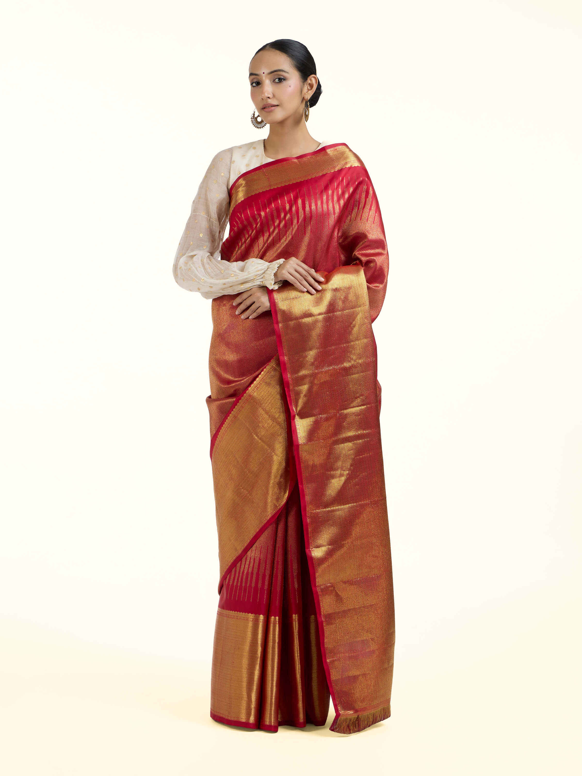Front view of red silk Kancheepuram saree with rich zari woven motifs