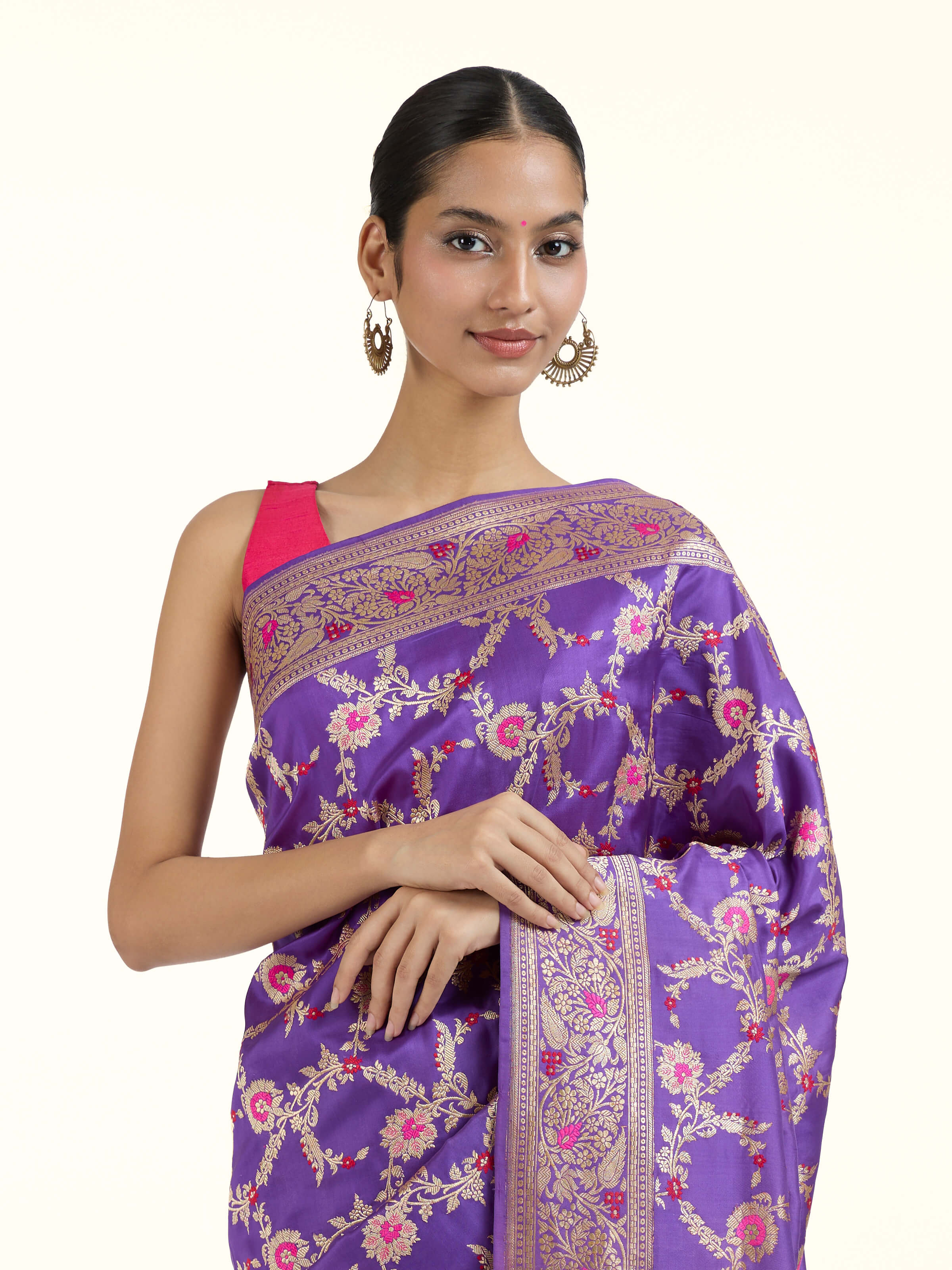 Angled view of purple mulberry katan silk Banarasi saree highlighting woven patterns
