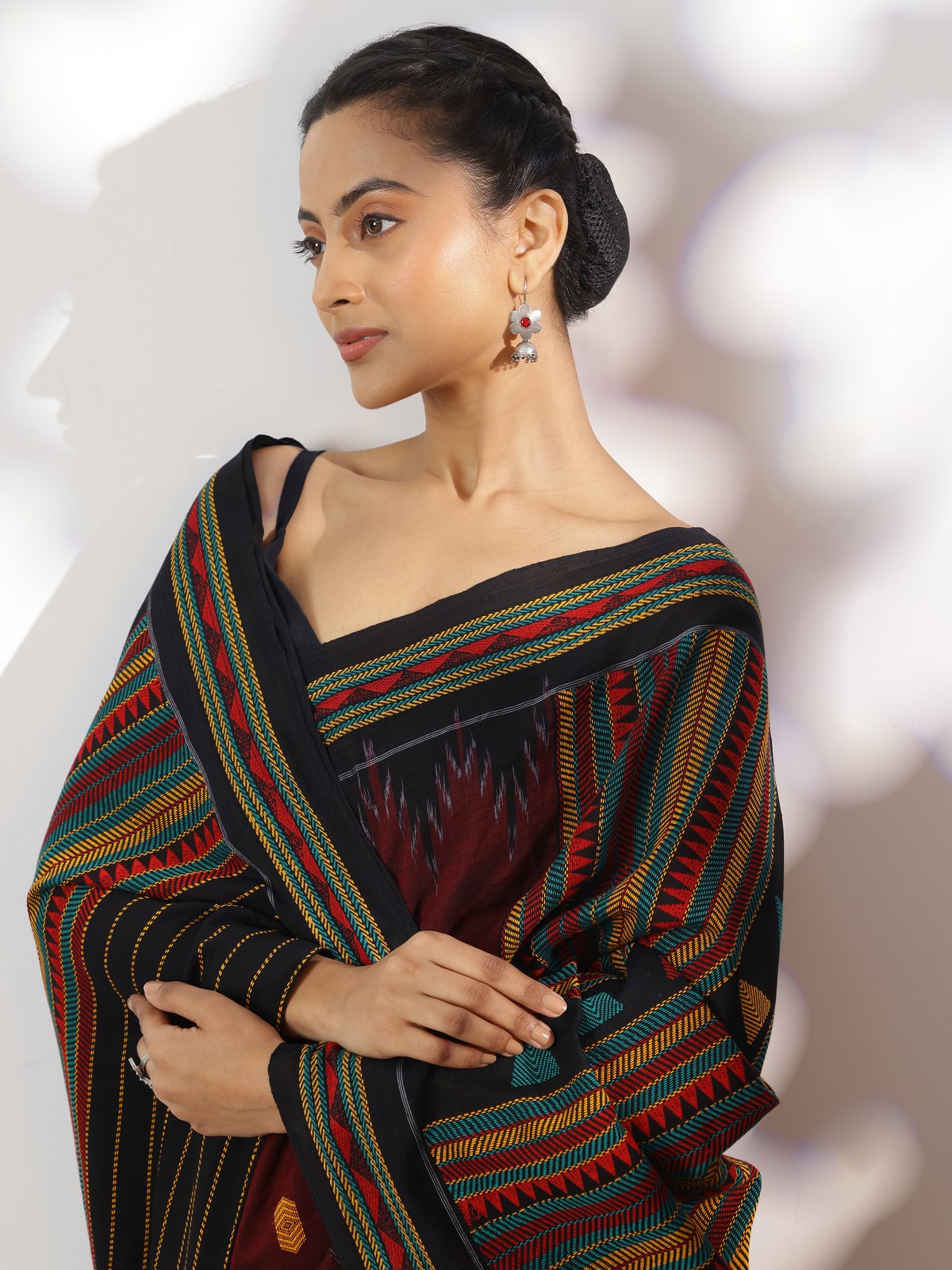 Side view of red cotton Dongaria saree with soft drape and traditional white tribal detailing