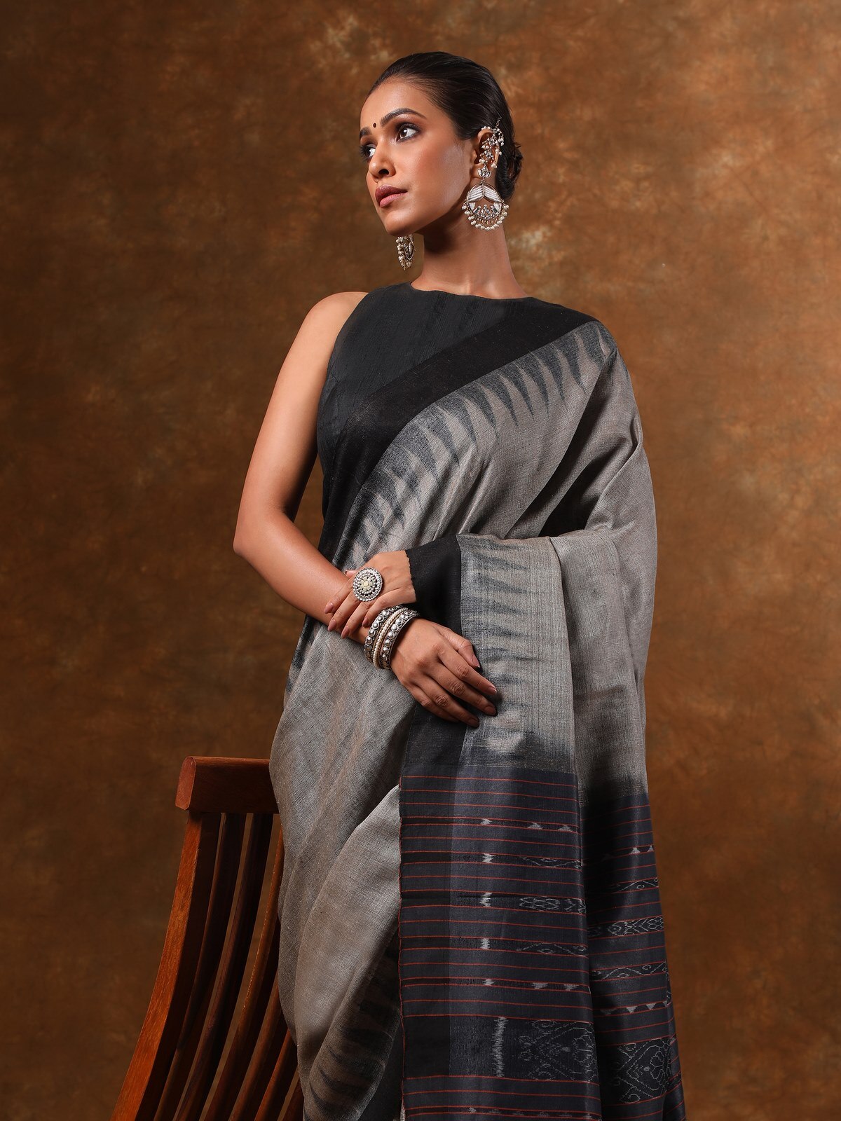 Side lifestyle view showing texture and border design of Ikat silk saree