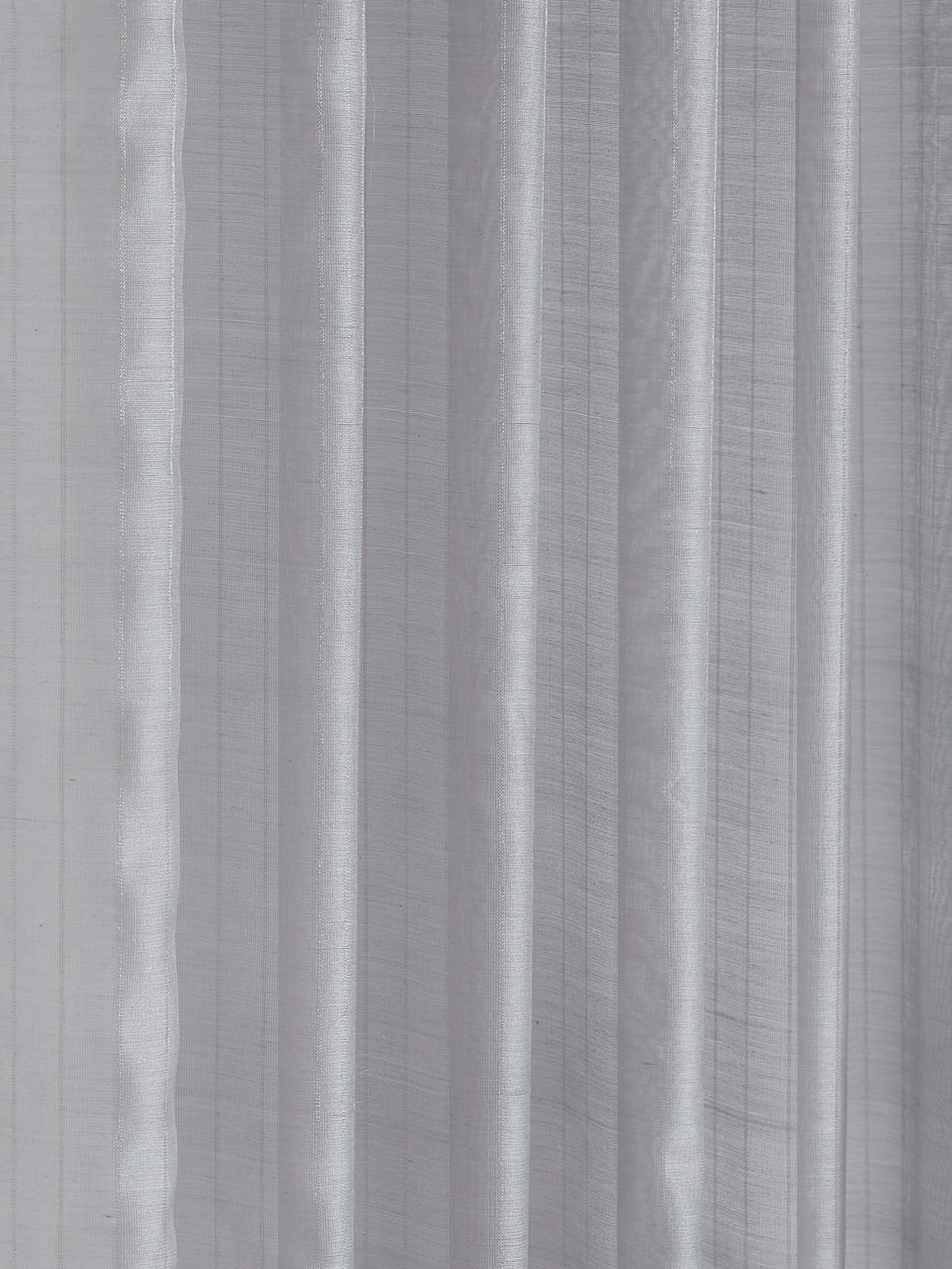 Close-up of textured weave and metallic stripes on grey Maheshwari handloom sheer curtain.