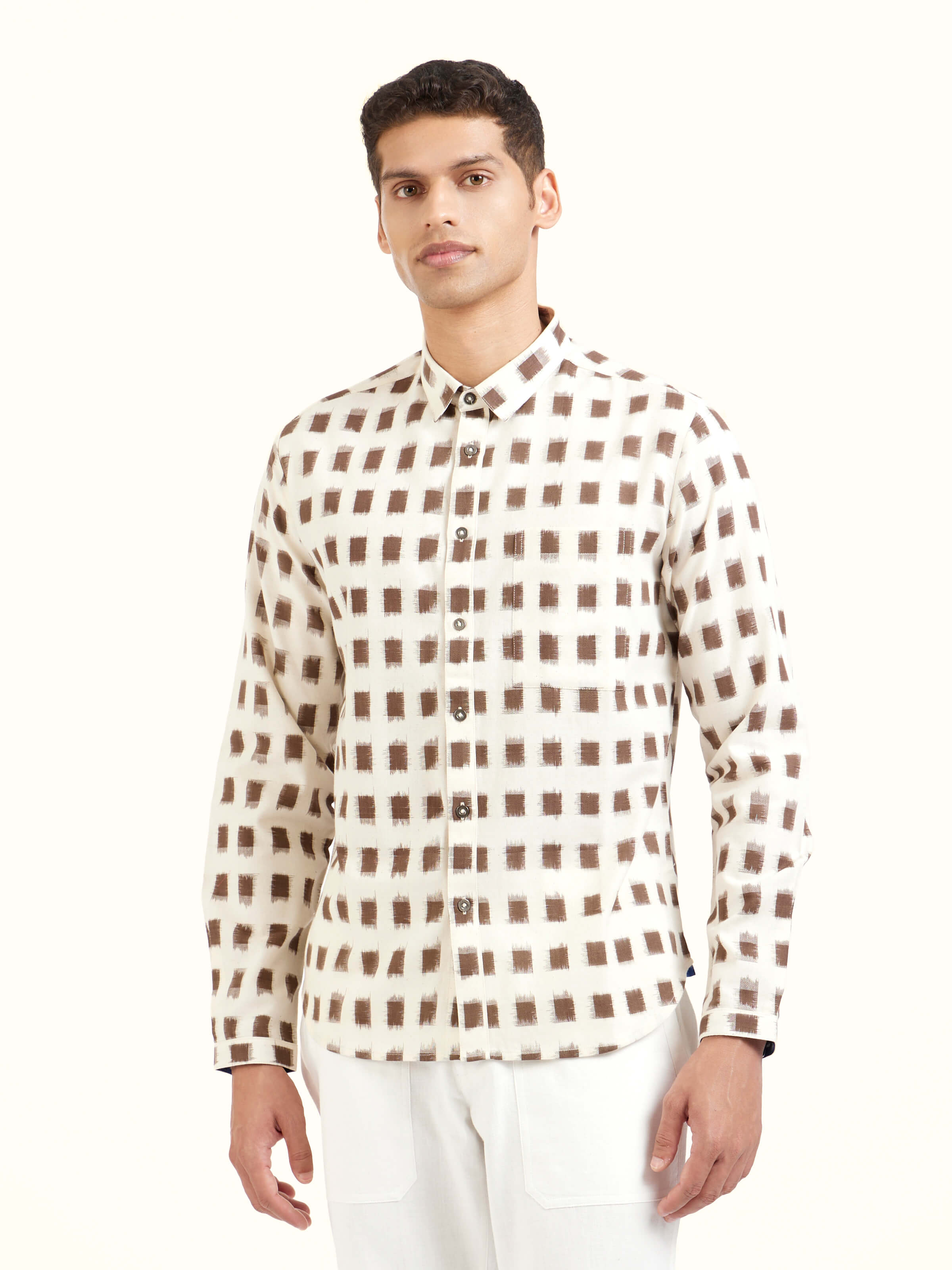 Angled view of white cotton Telangana Ikat shirt emphasizing fabric weave