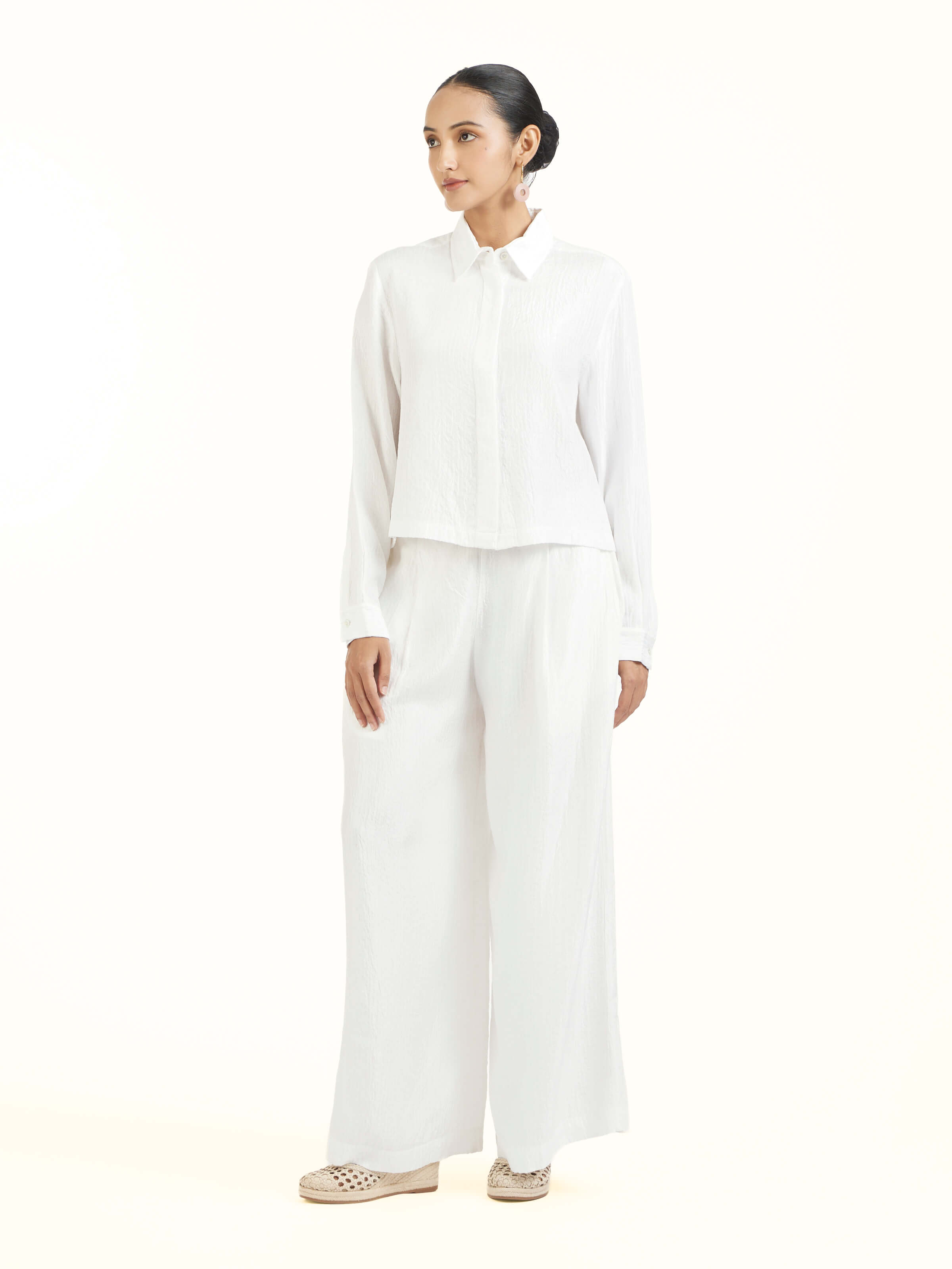 Side view of ivory quilted silk pants showcasing tailored fit
