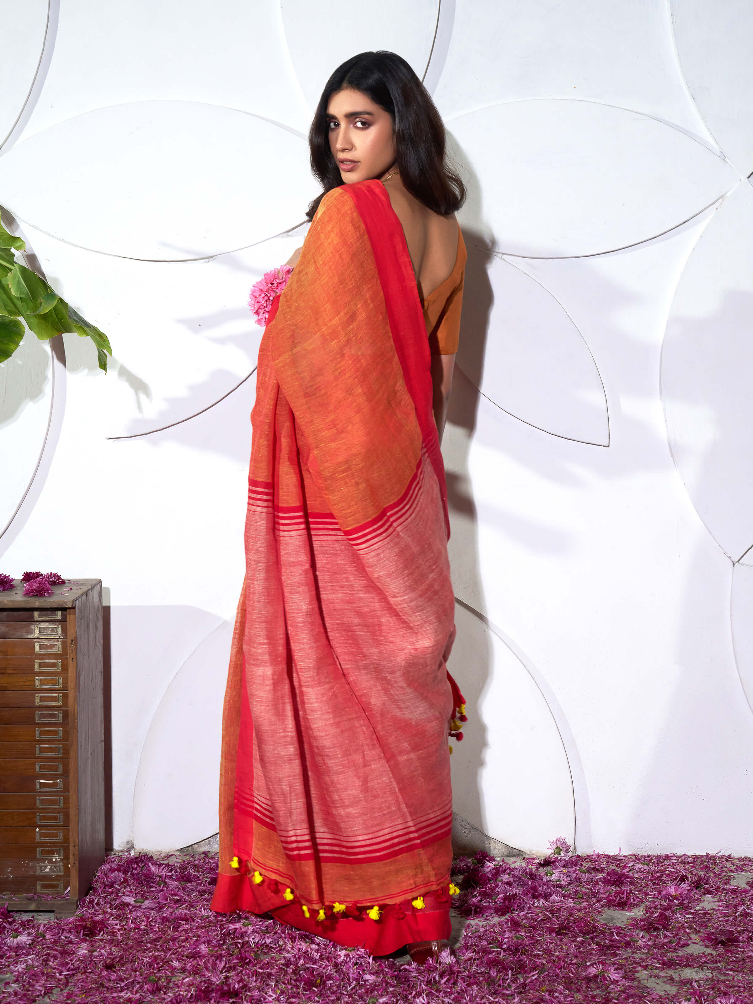 Angled view of orange linen saree emphasizing natural linen weave