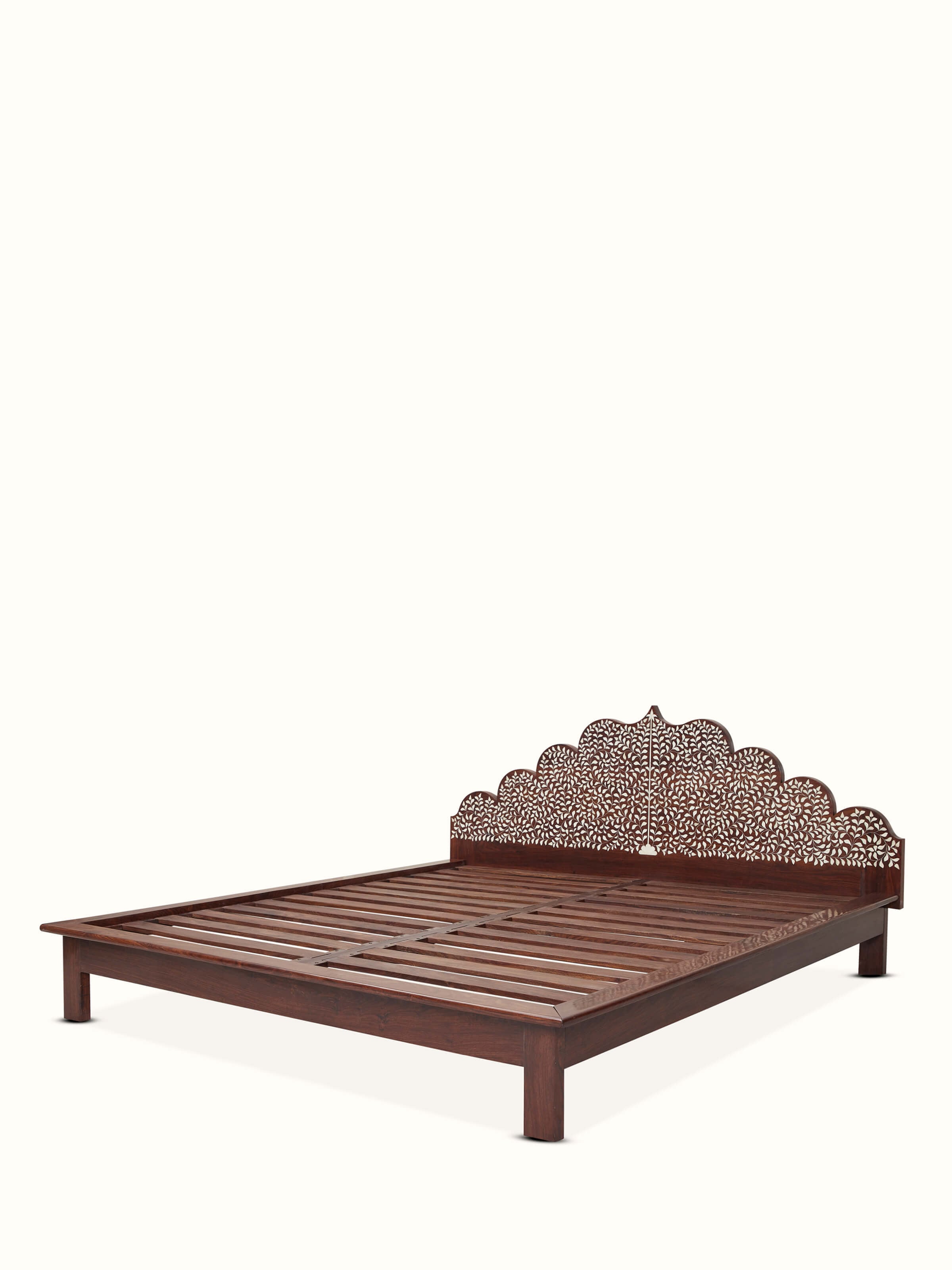 Angled view of Sheesham wood king size bed with bone inlay, highlighting detailed craftsmanship and elegant design.