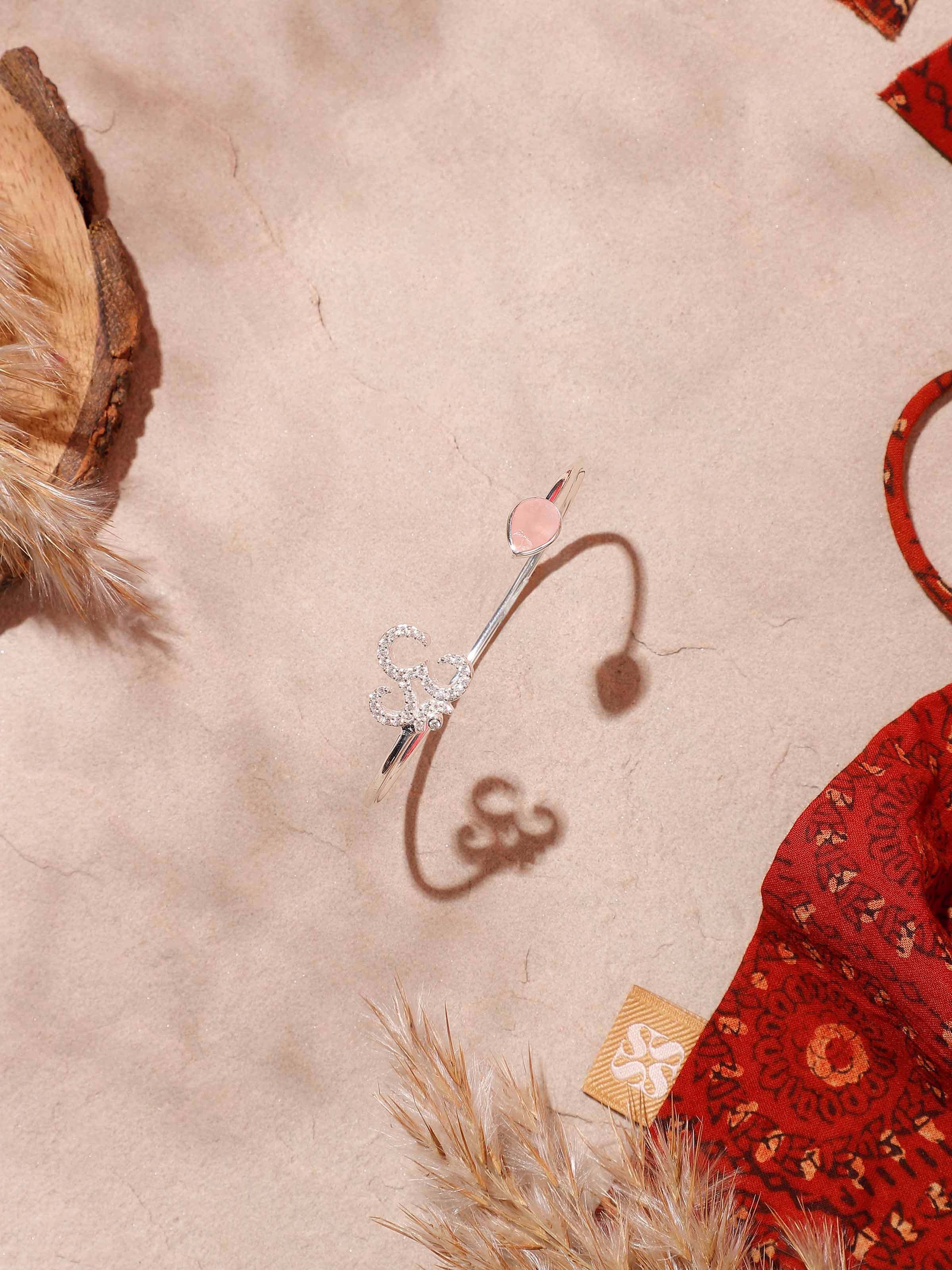 Side view of Rose Quartz & Om Bracelet, showcasing the calming gemstones and silver detailing