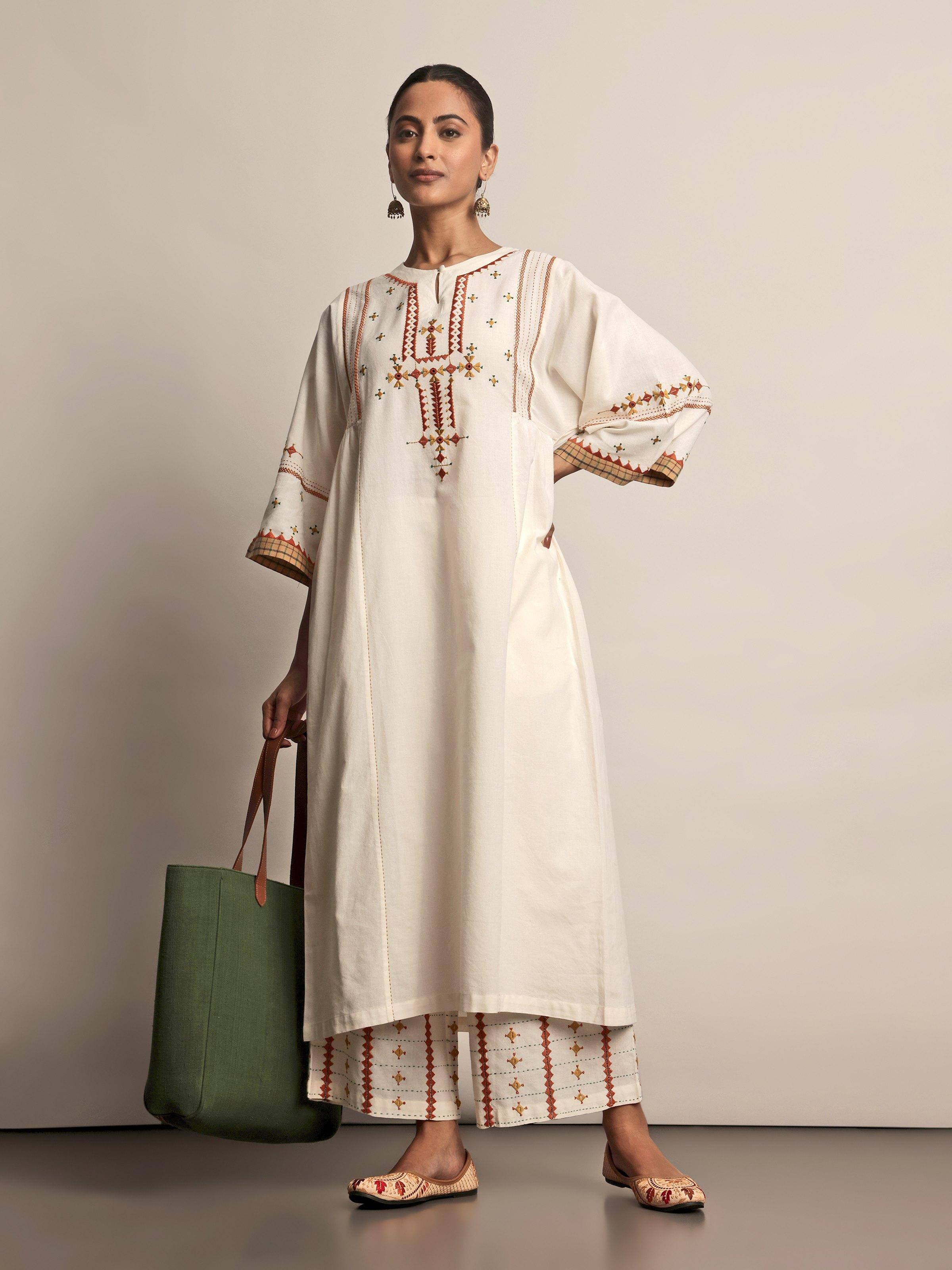 Angled view of Off-white Cotton Rajasthani Embroidered Palazzo showing fine embroidery and cotton fabric texture.