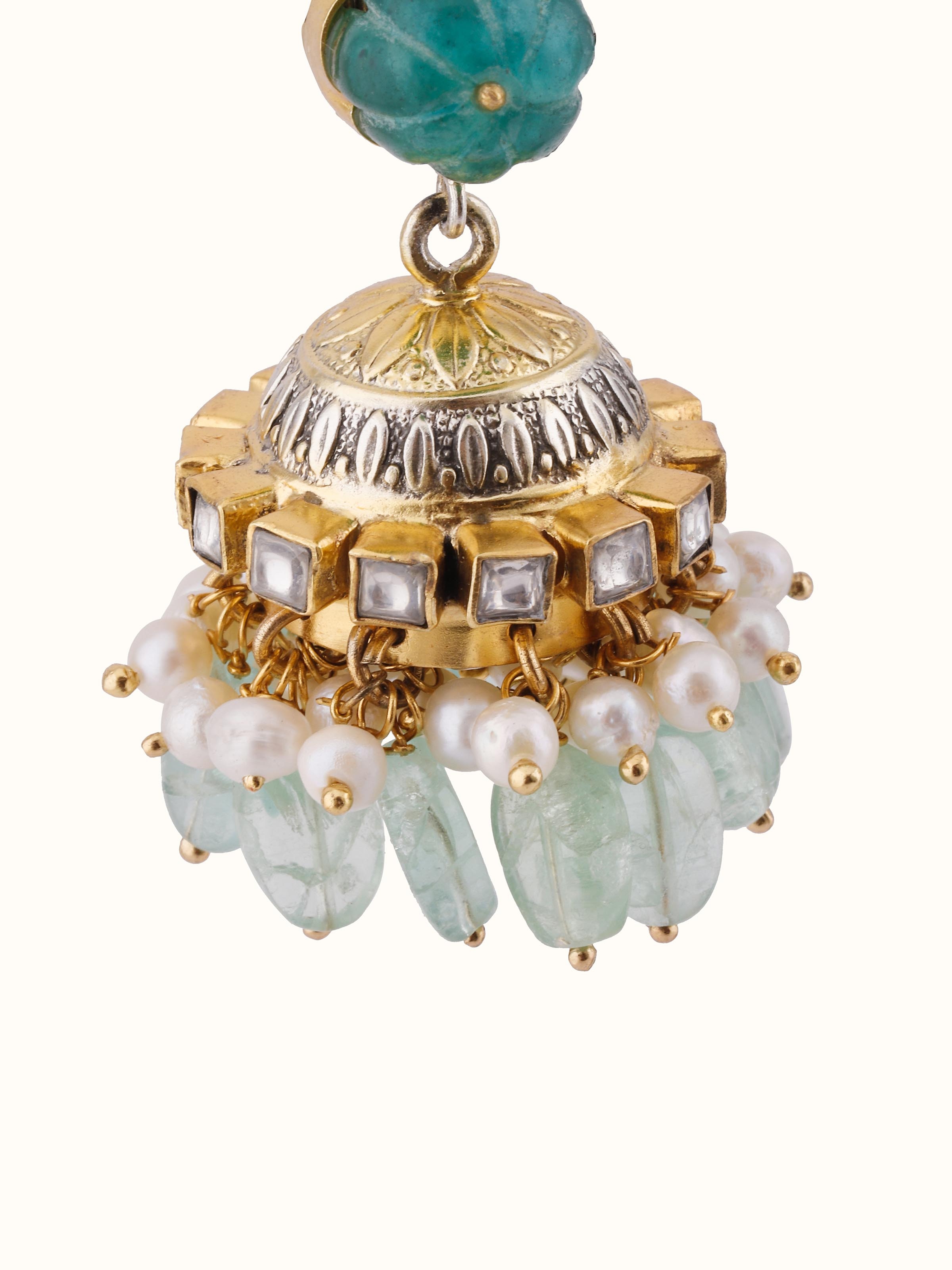 Overhead view of Silver Smithing jhumkas revealing symmetrical structure and ornate silver finish.