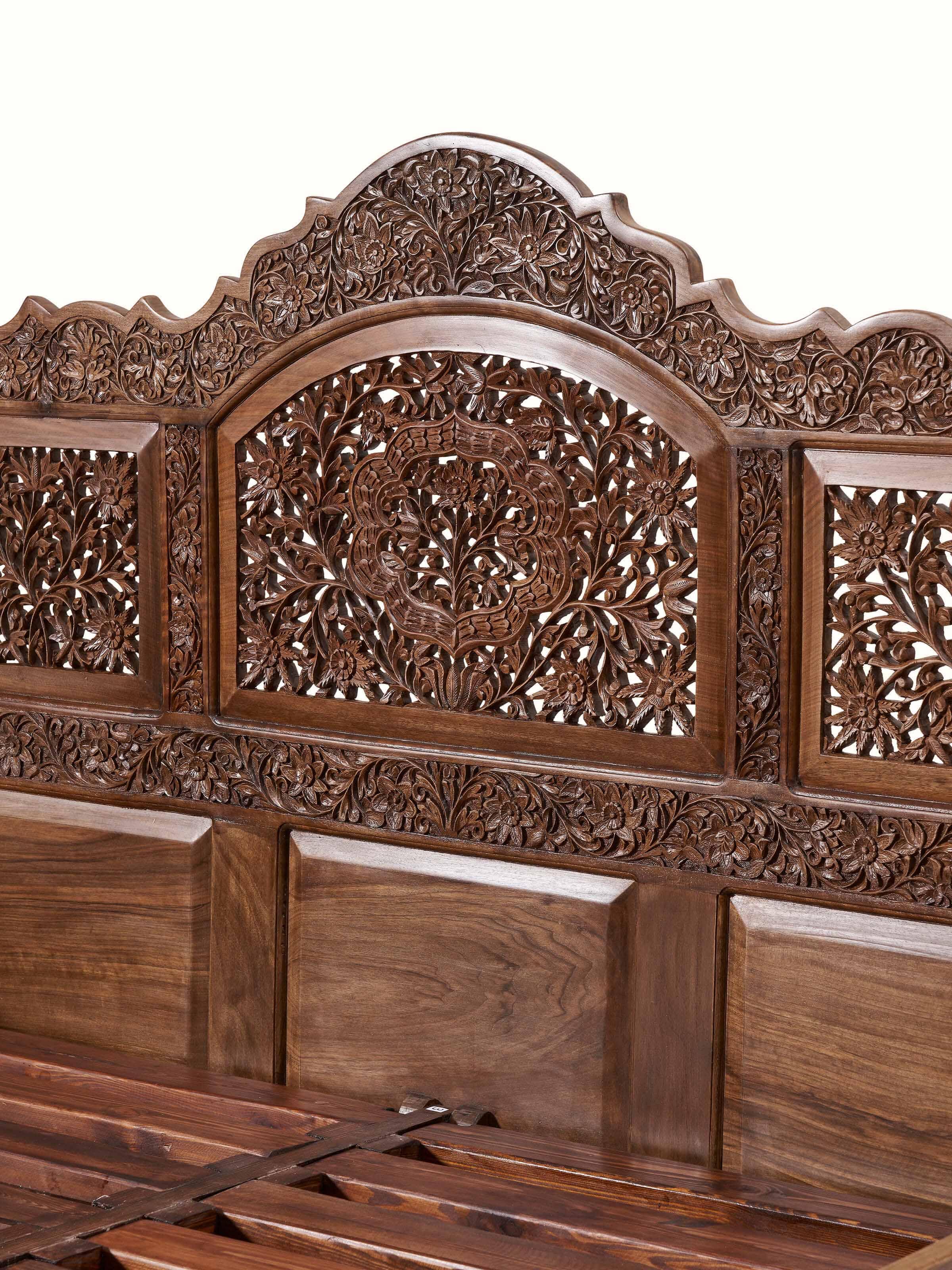 Side view of carved walnut wood queen size bed, emphasizing the craftsmanship and elegant design elements.