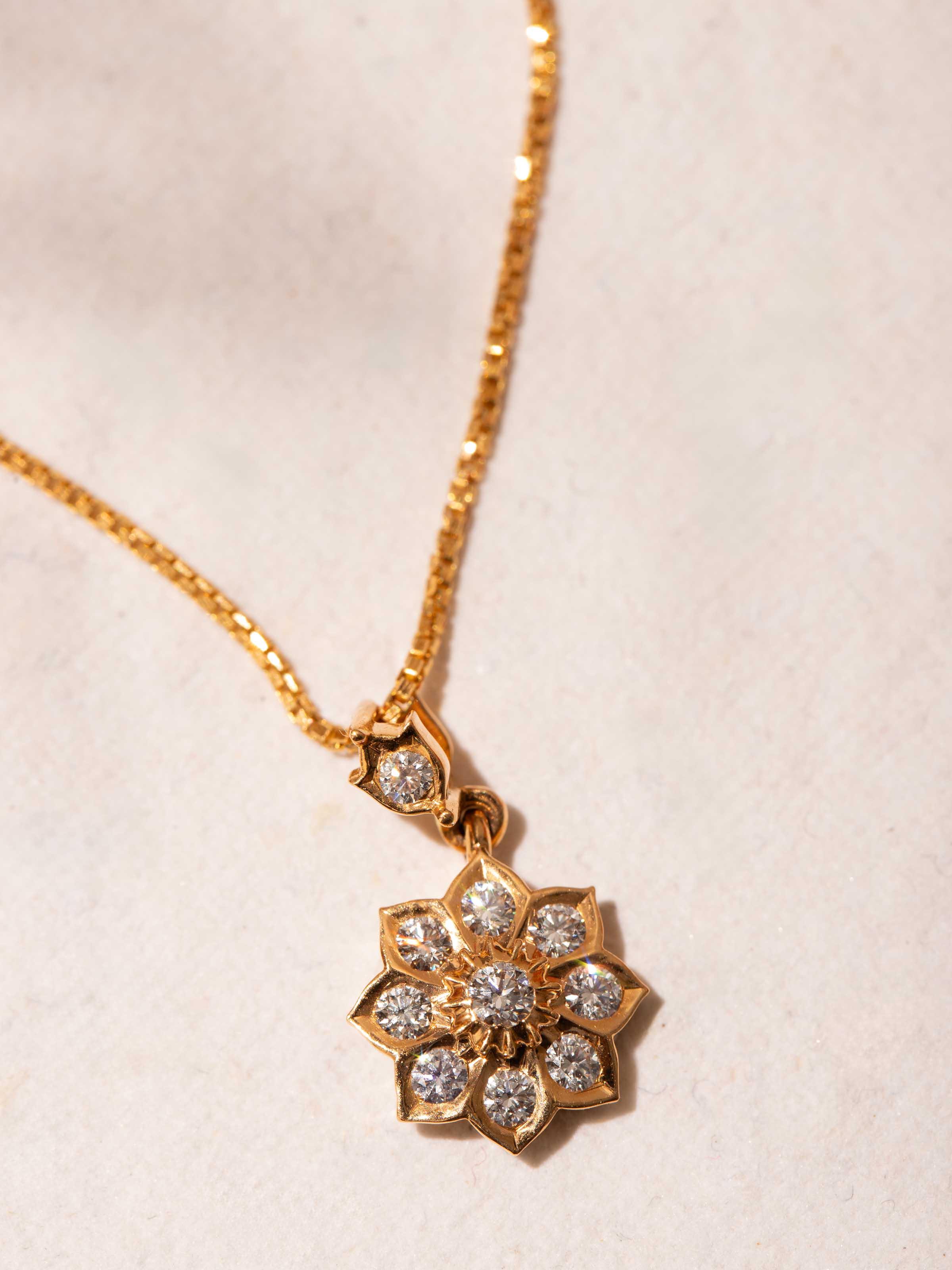 Overhead view of Close-setting 22 Karat Gold Pendant & Chain by Swadesh emphasizing the sleek design and luxurious gold finish